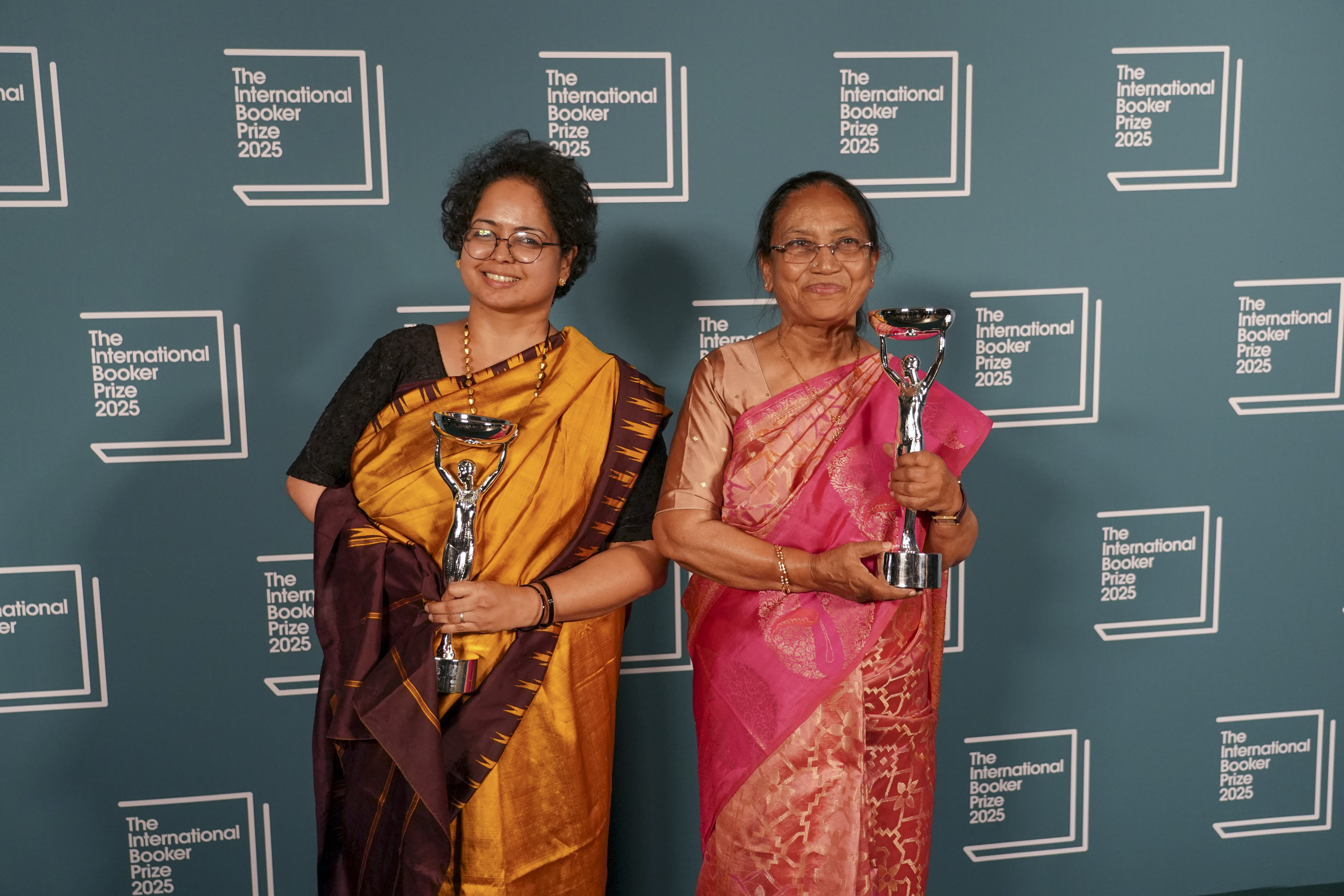 Banu Mushtaq, author of 'Heart Lamp', right, and Deepa Bhasthi hold the trophies after winning the International Booker Prize, in London, Tuesday, May 20, 2025.(AP Photo/Alberto Pezzali)