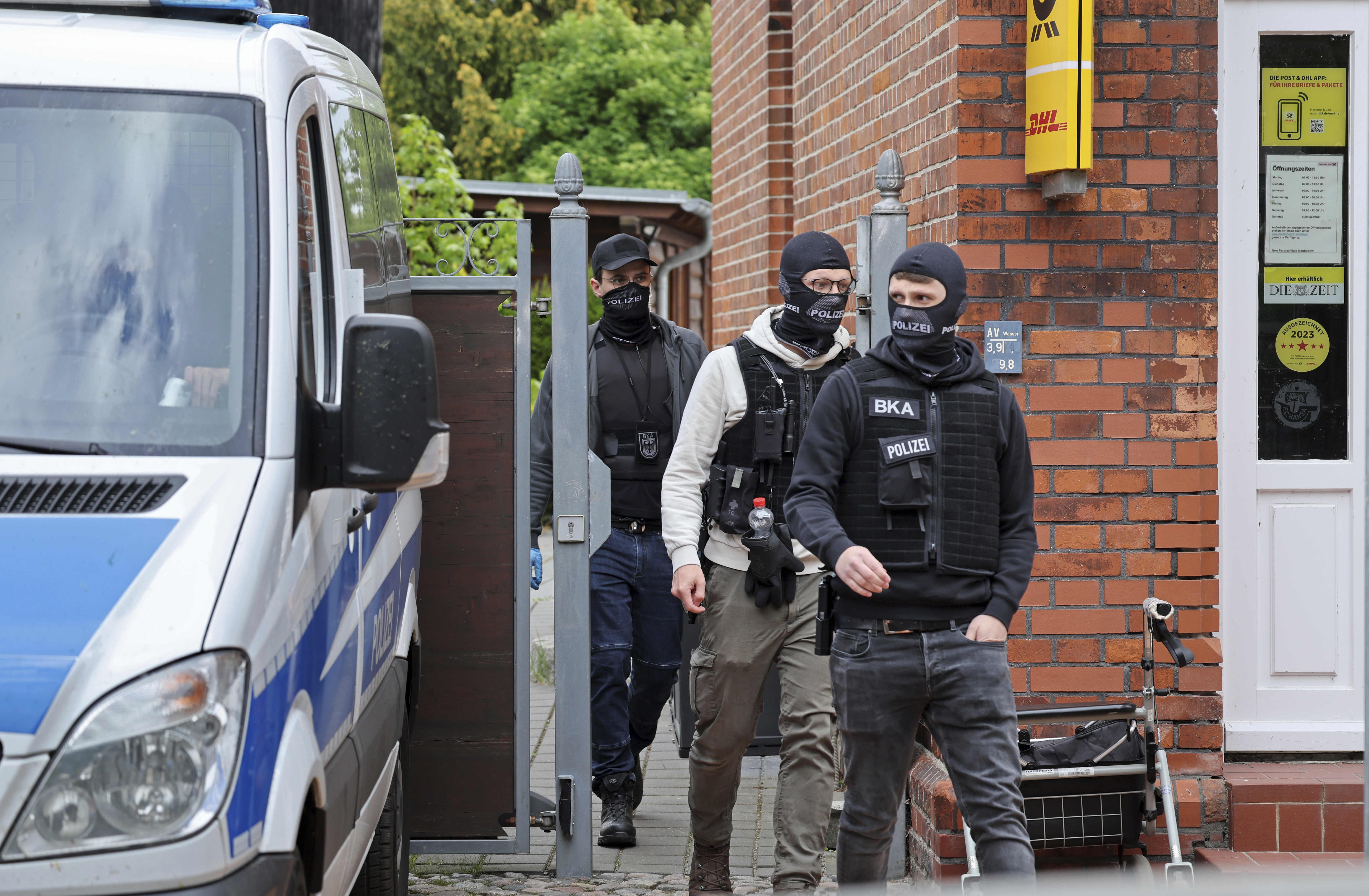 Police search rooms in the 'Altes Postamt' building in Neubukow, Germany, Wednesday, May 21, 2025. (Bernd Wuestneck/dpa via AP)