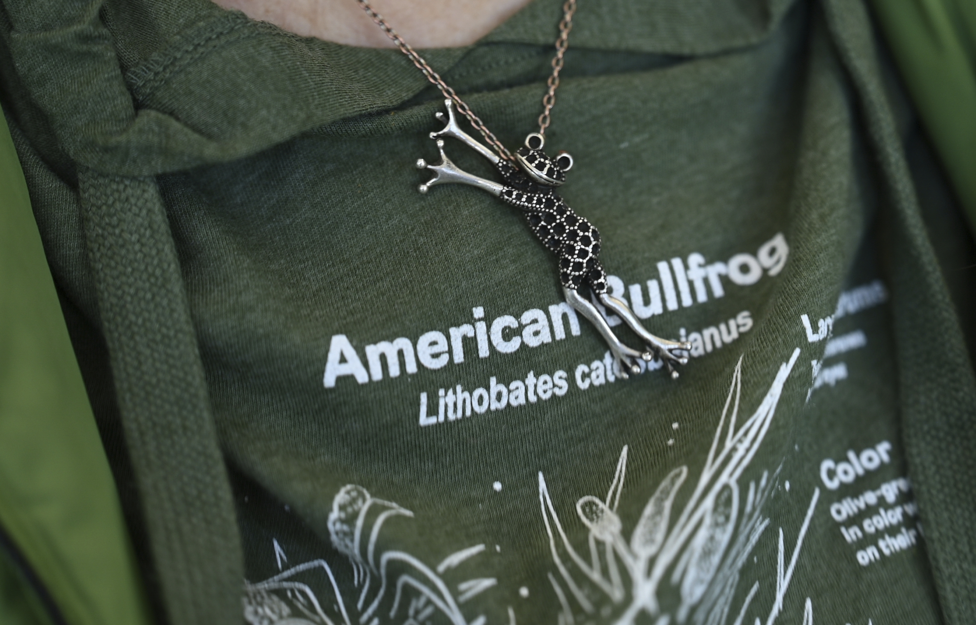 Margot Fass wears a frog pendant Friday, March 21, 2025, in Pittsford, N.Y. (AP Photo/Maryel Pryce)