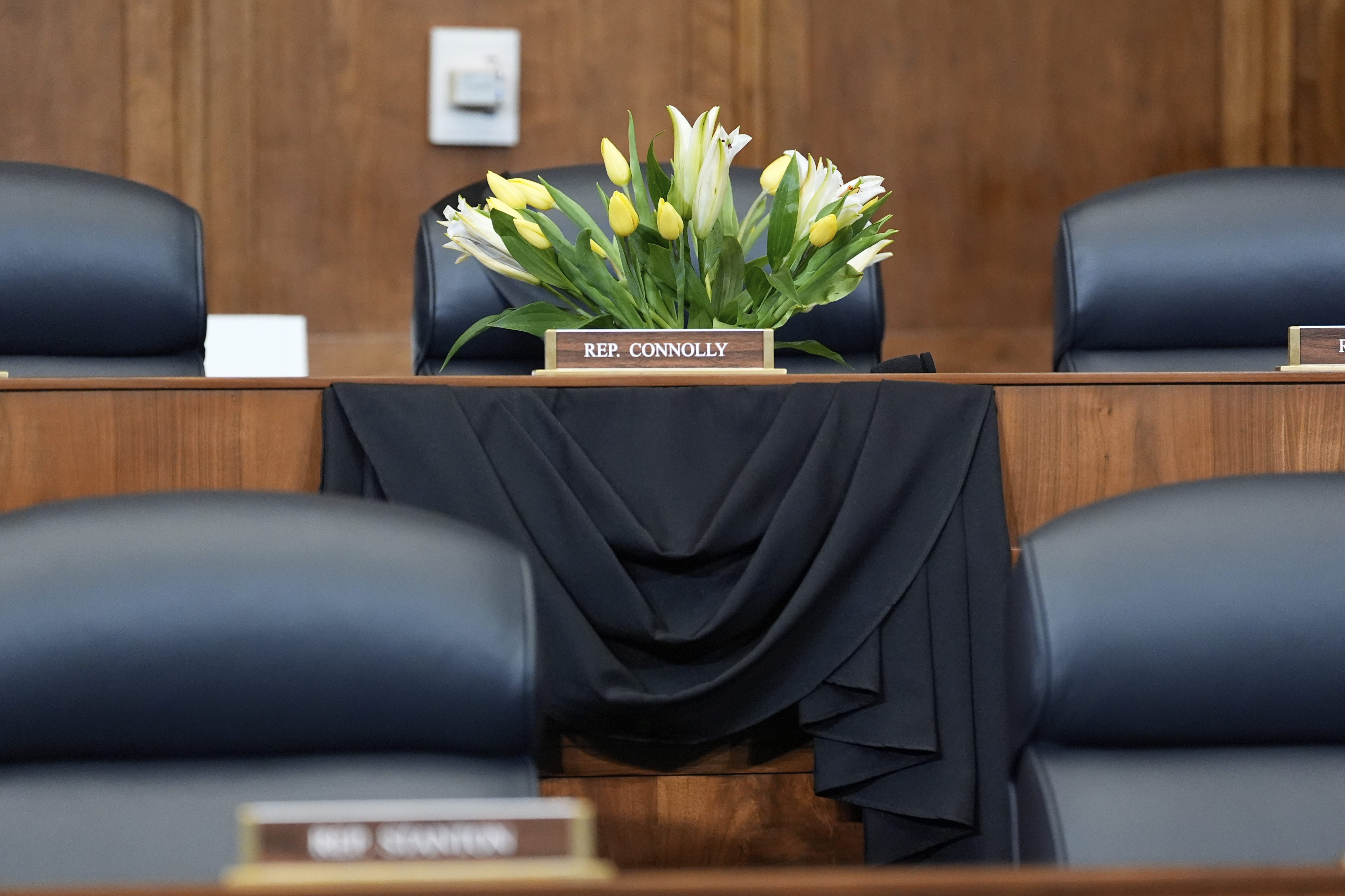 Flowers are seen at the seat of Rep. Gerald Connolly, D-Va., before the start of a House Committee on Foreign Affairs hearing, Wednesday, May 21, 2025, in Washington. Connolly, a Democratic congressman and fixture of Virginia politics, has died at 75. (AP Photo/Mark Schiefelbein)