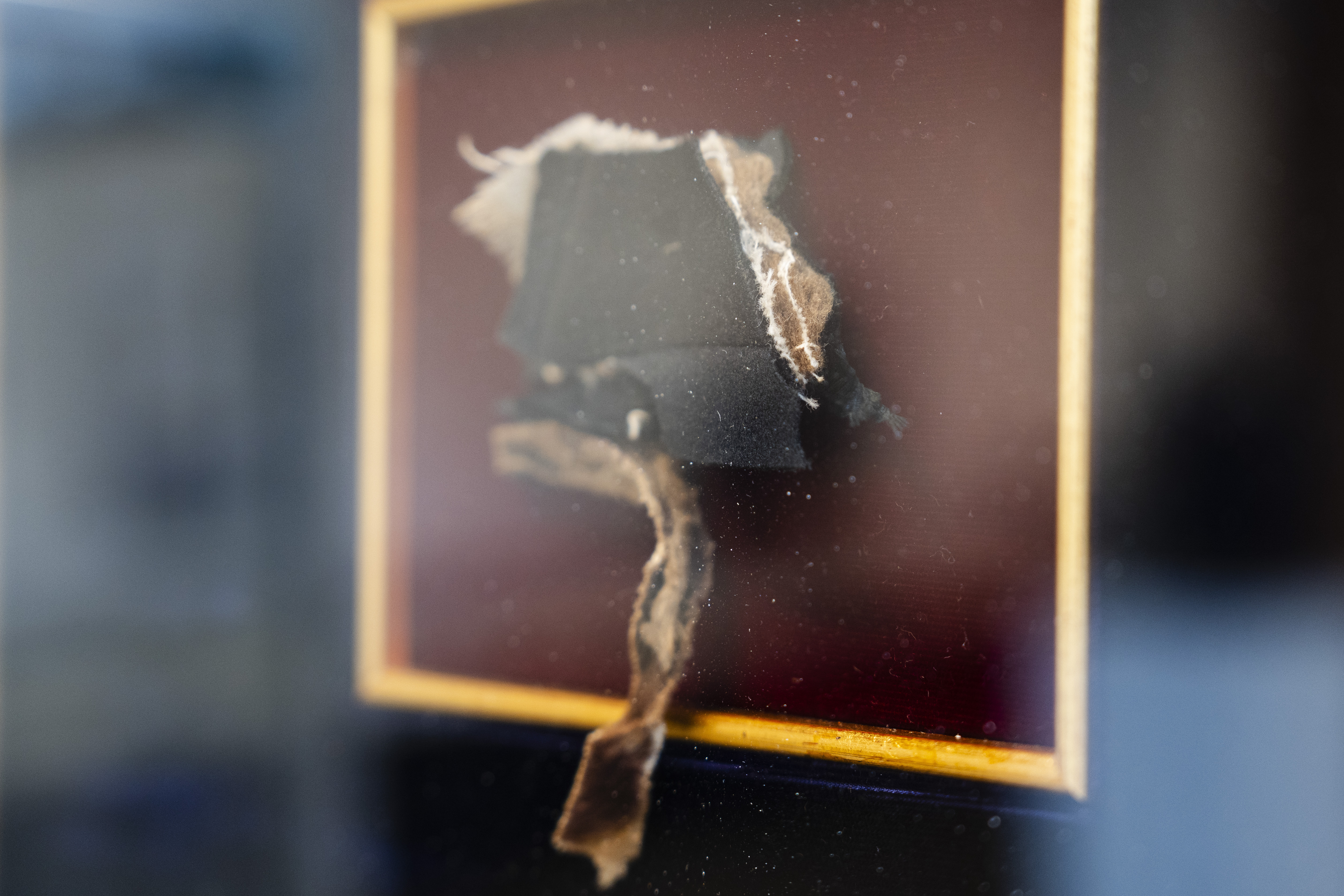 A piece of Abraham Lincoln's coat, which he wore when he was assassinated at Ford's Theatre on April 14, 1865, is framed at Freeman's | Hindman in West Loop, Chicago, May 15, 2025. (Pat Nabong/Chicago Sun-Times via AP)