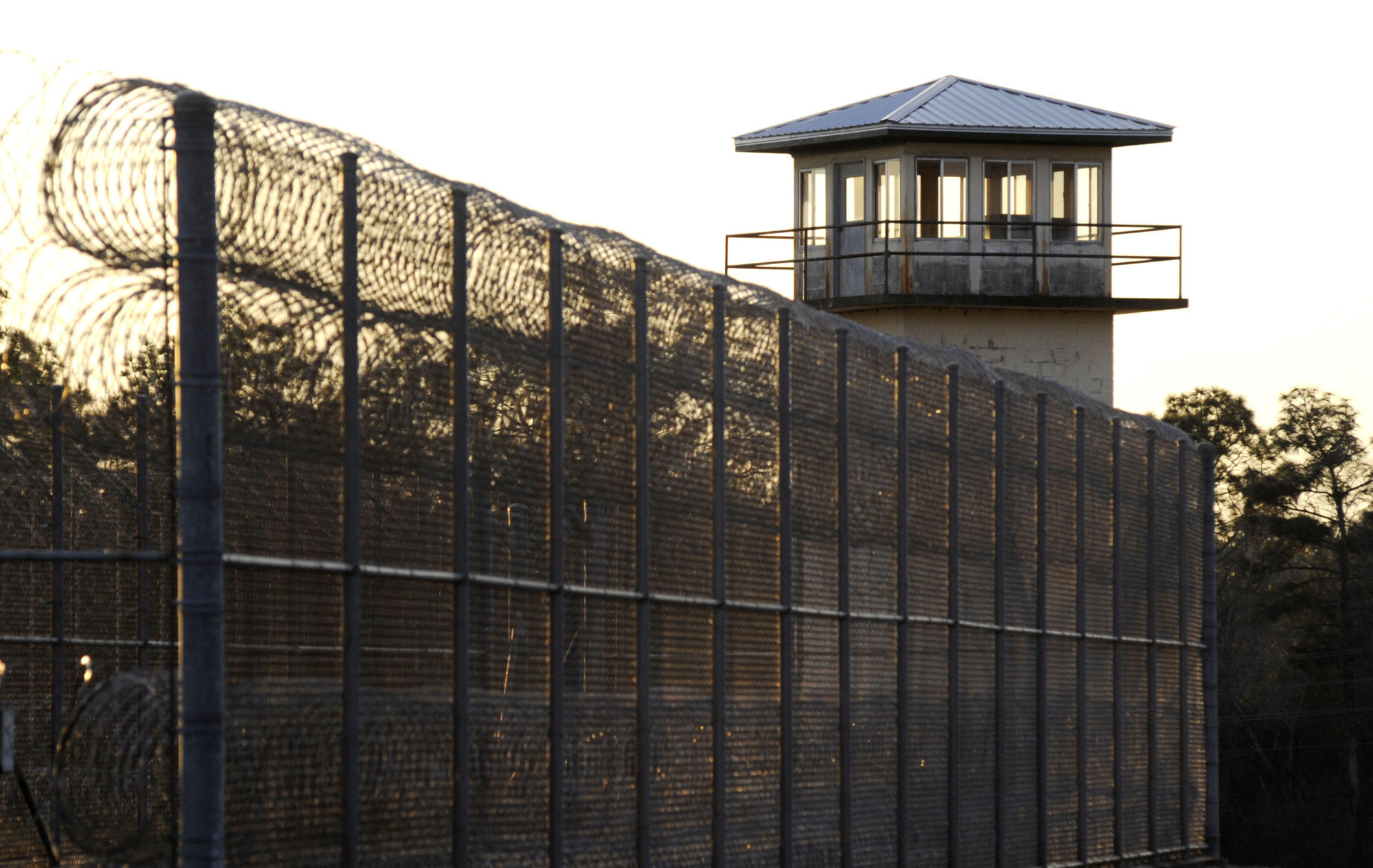 FILE - The sun sets behind Holman Prison in Atmore, Ala., Jan., 27, 2022. (AP Photo/Jay Reeves, File)