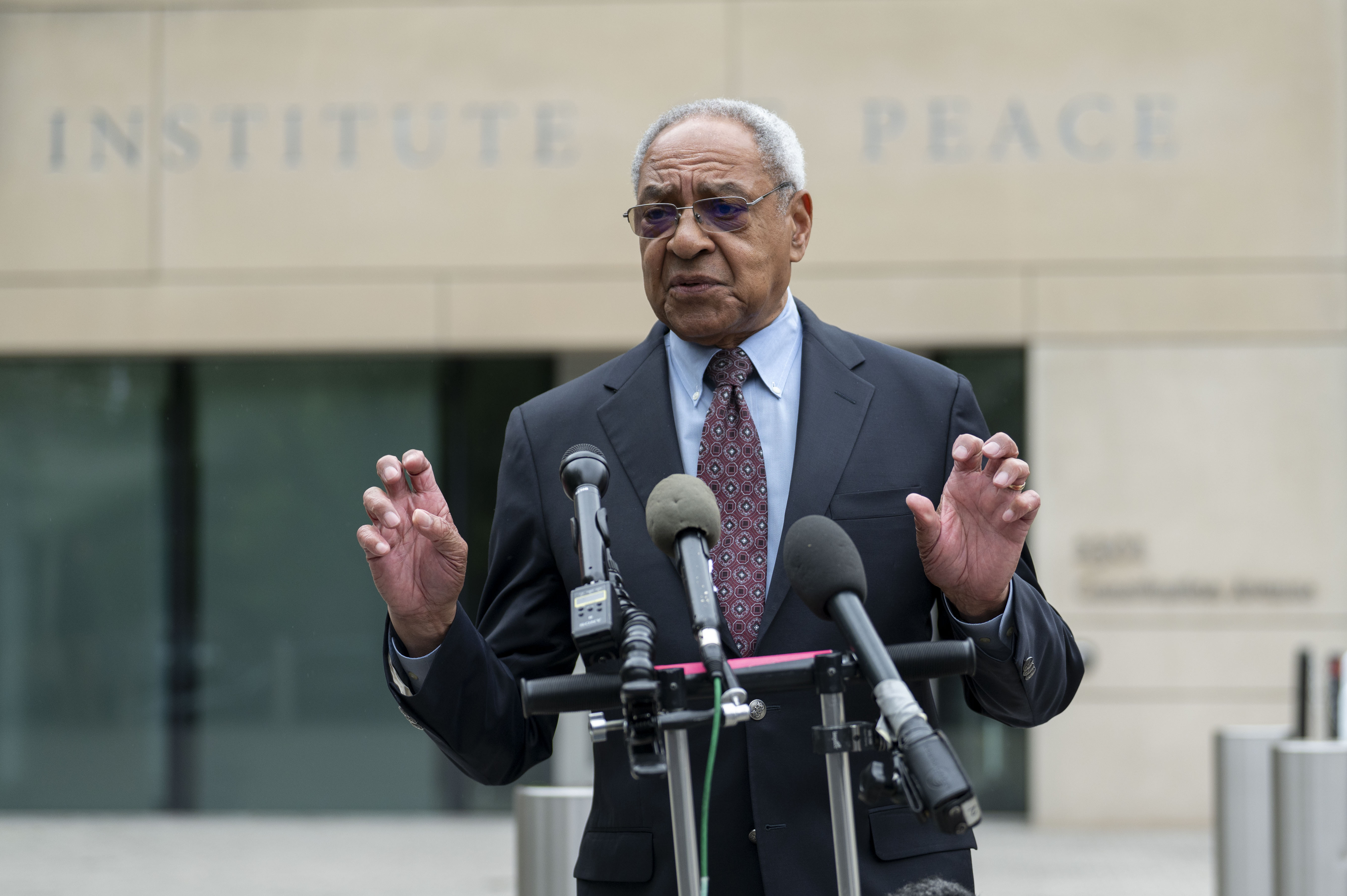 U.S. Institute of Peace acting President George Moose talks during a news conference outside the Institute, Wednesday, May 21, 2025 in Washington. (AP Photo/Kevin Wolf)