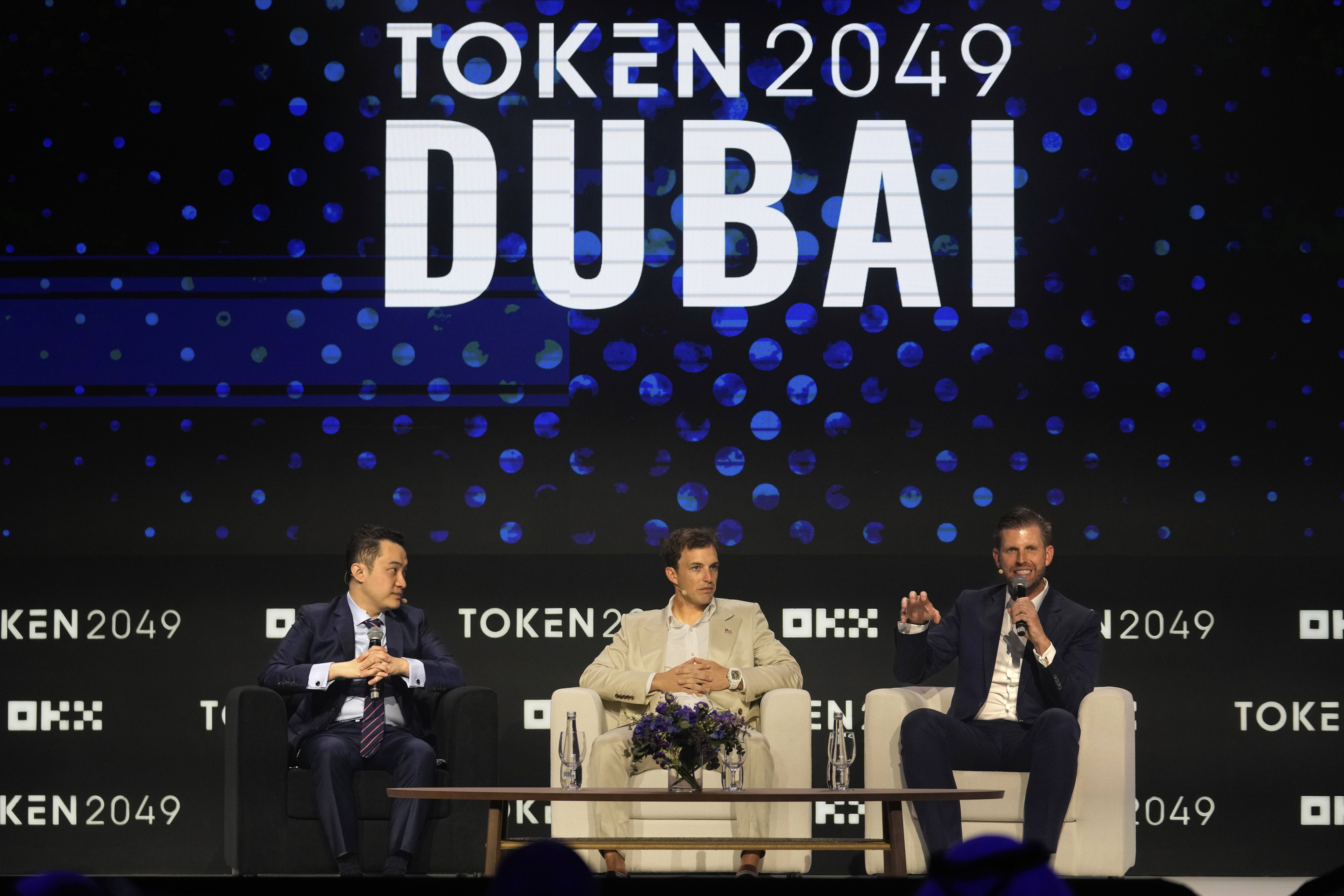 Eric Trump, Executive VP of The Trump Organization, right, speaks as Co-founder of World Liberty Financial Zach Witkoff, centre, and Founder of TRON Justin Sun look on during Token 2049, a Crypto event, in Dubai, United Arab Emirates, Thursday, May 1, 2025. (AP Photo/Altaf Qadri)