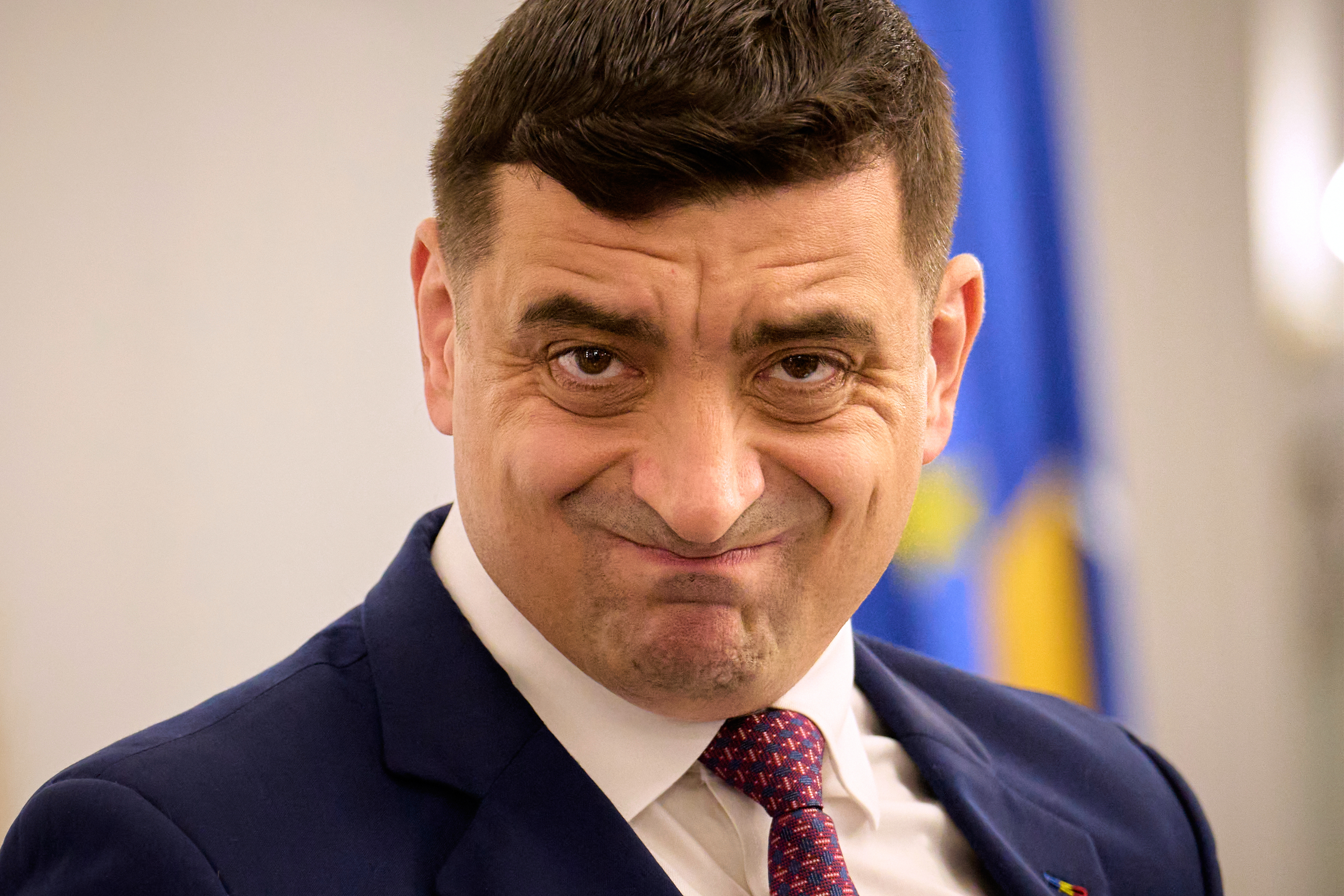 Presidential candidate George Simion waits to address members of the business community at the Chamber of Commerce and Industry of Romania, days ahead of the second round of the presidential election redo in Bucharest, Romania, Tuesday, May 13, 2025. (AP Photo/Vadim Ghirda)