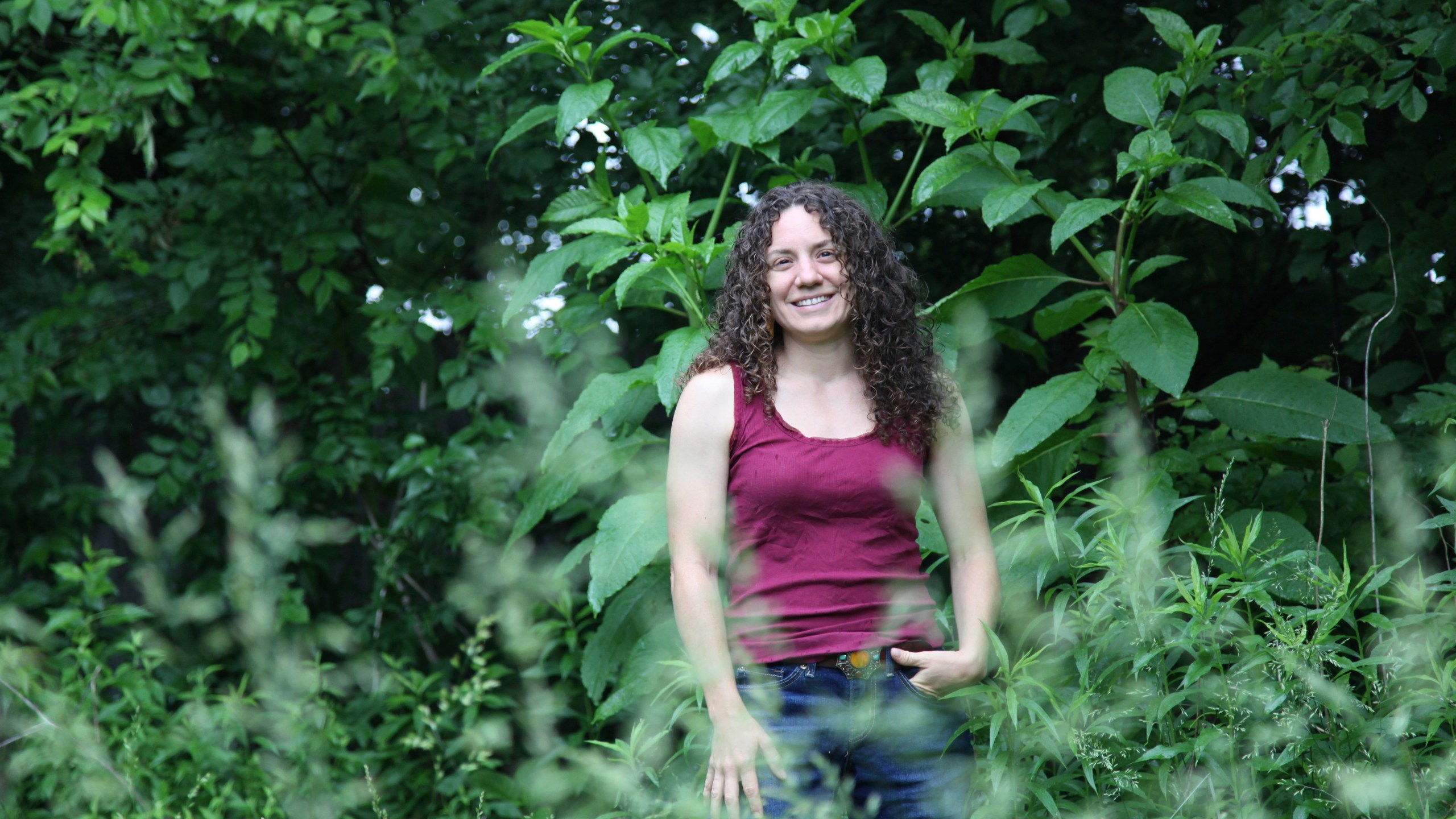 Amanda Beltranmini Healen stands among the plants in her backyard in Nashville, Tenn., Monday, May 19, 2025, where she participates in No Mow Months to improve water retention and encourage pollinators. (AP Photo/Kristin M. Hall)