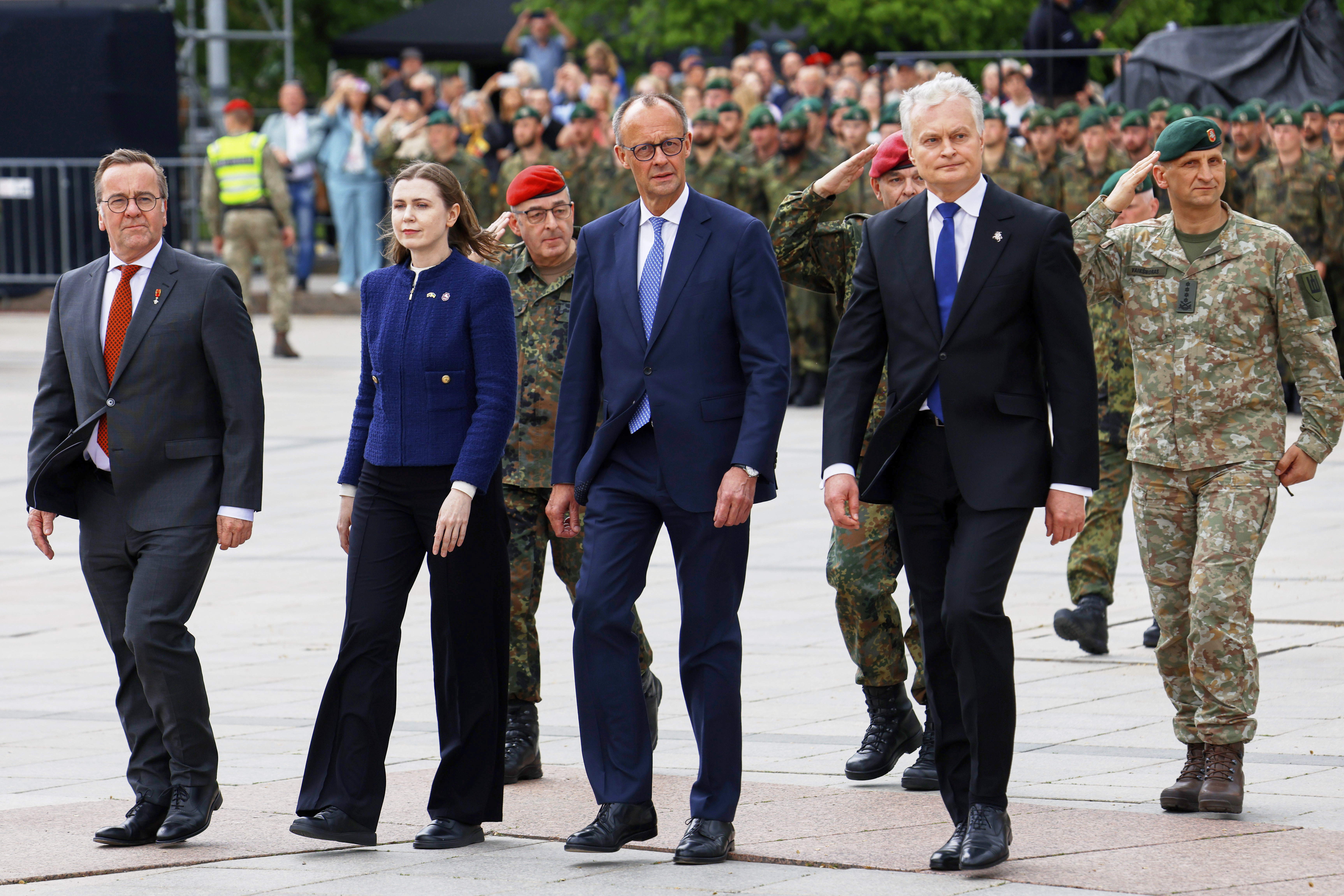Lithuania's President Gitanas Nauseda, German Chancellor Friedrich Merz, Lithuania's defense minister Docile Sakaliene and German Defense Minister Boris Pistorius, from right, participate a formal inauguration of a German brigade for NATO's eastern flank in Vilnius, Lithuania, Thursday, May 22, 2025. (AP Photo/Mindaugas Kulbis)