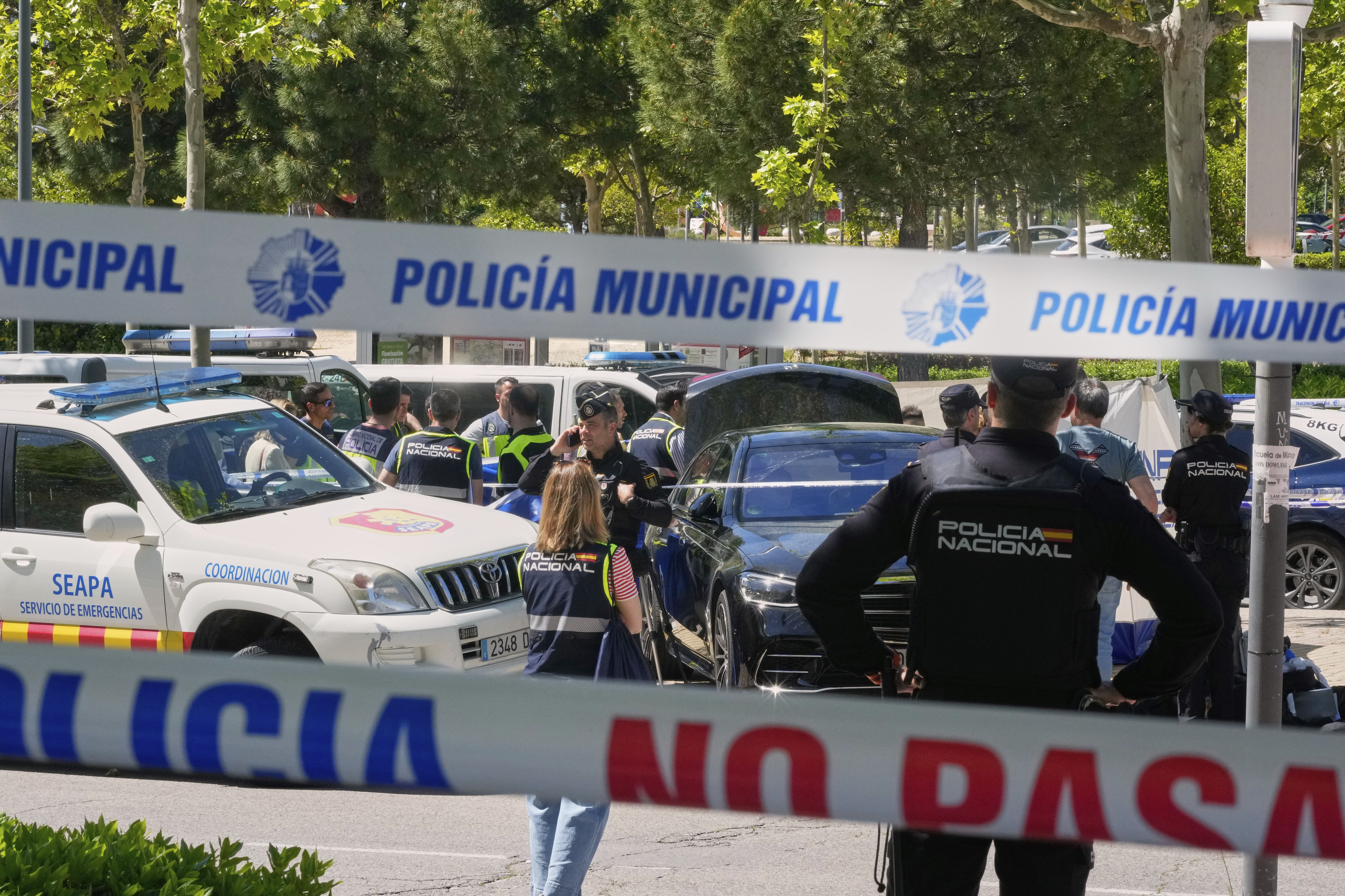 Police officers cordon off the area after an adviser to former Ukrainian president Viktor Yanukovych was shot, outside a school in Madrid, Spain, Wednesday, May 21, 2025. (AP Photo/Paul White)