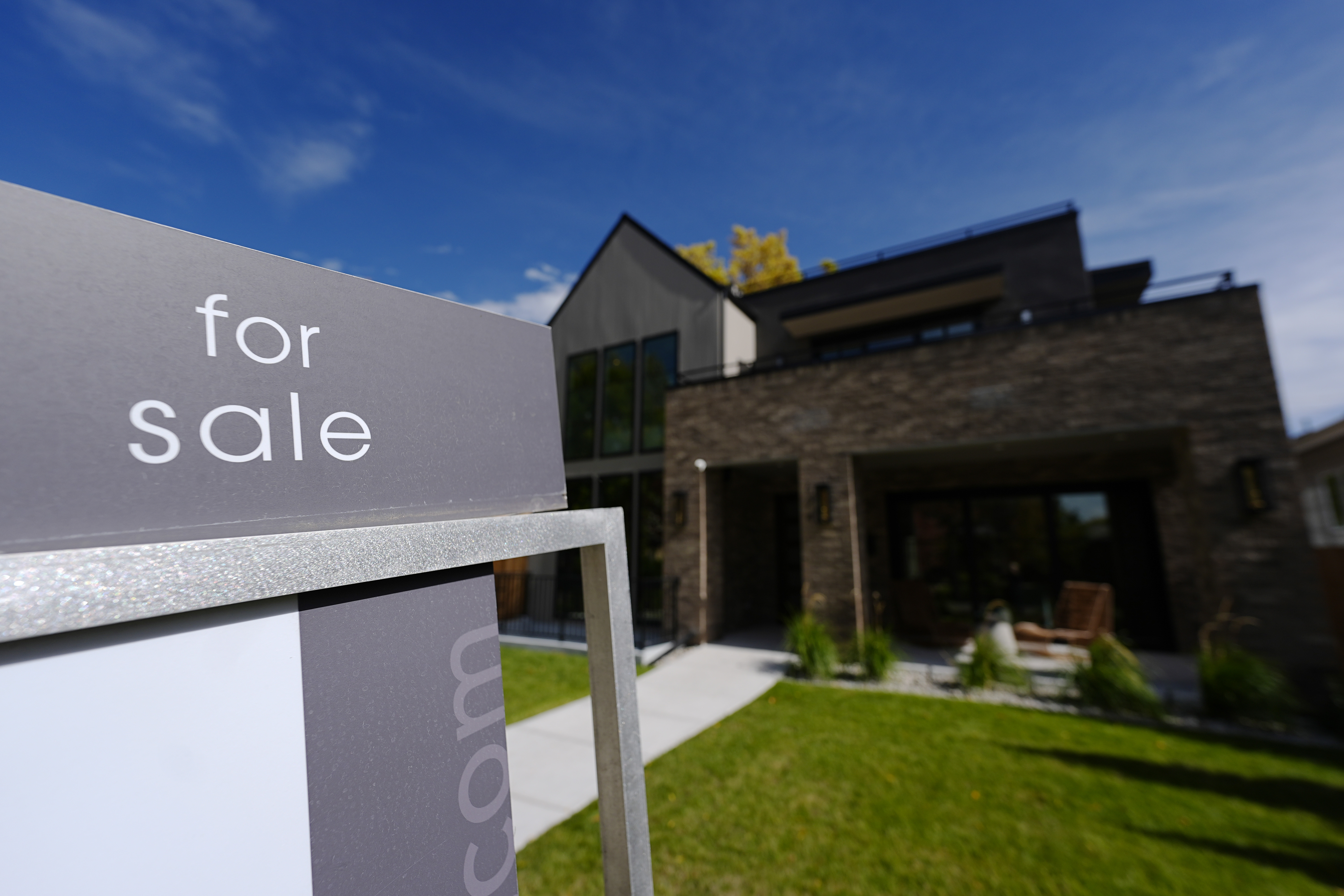 FILE - A sale sign stands outside a home on the market Thursday, Oct. 17, 2024, in the east Washington Park neighborhood of Denver. (AP Photo/David Zalubowski, File)