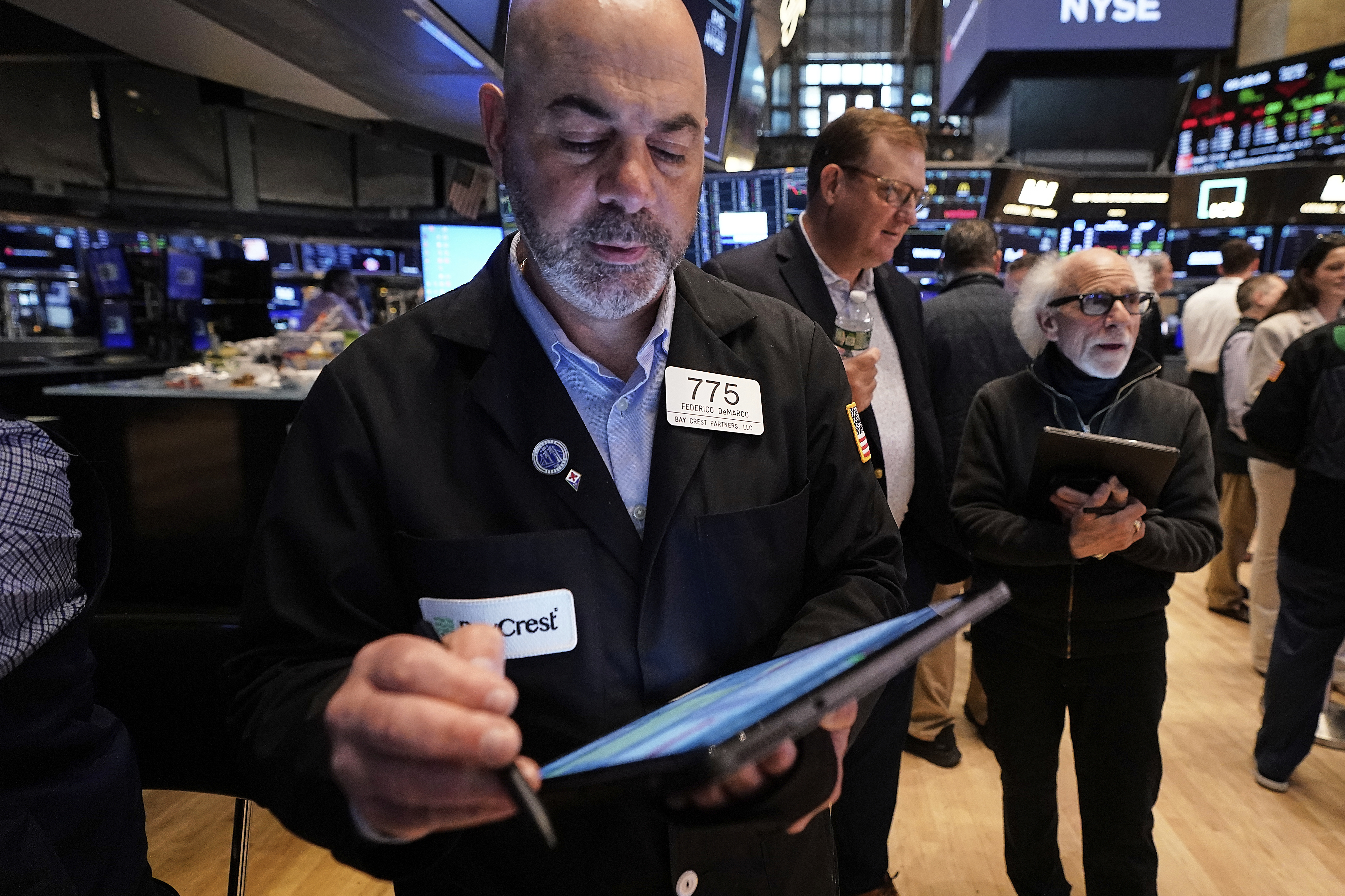 Traders Fred Demarco, left, and Peter Tuchman, right, work on the floor of the New York Stock Exchange, Tuesday, May 20, 2025. (AP Photo/Richard Drew)