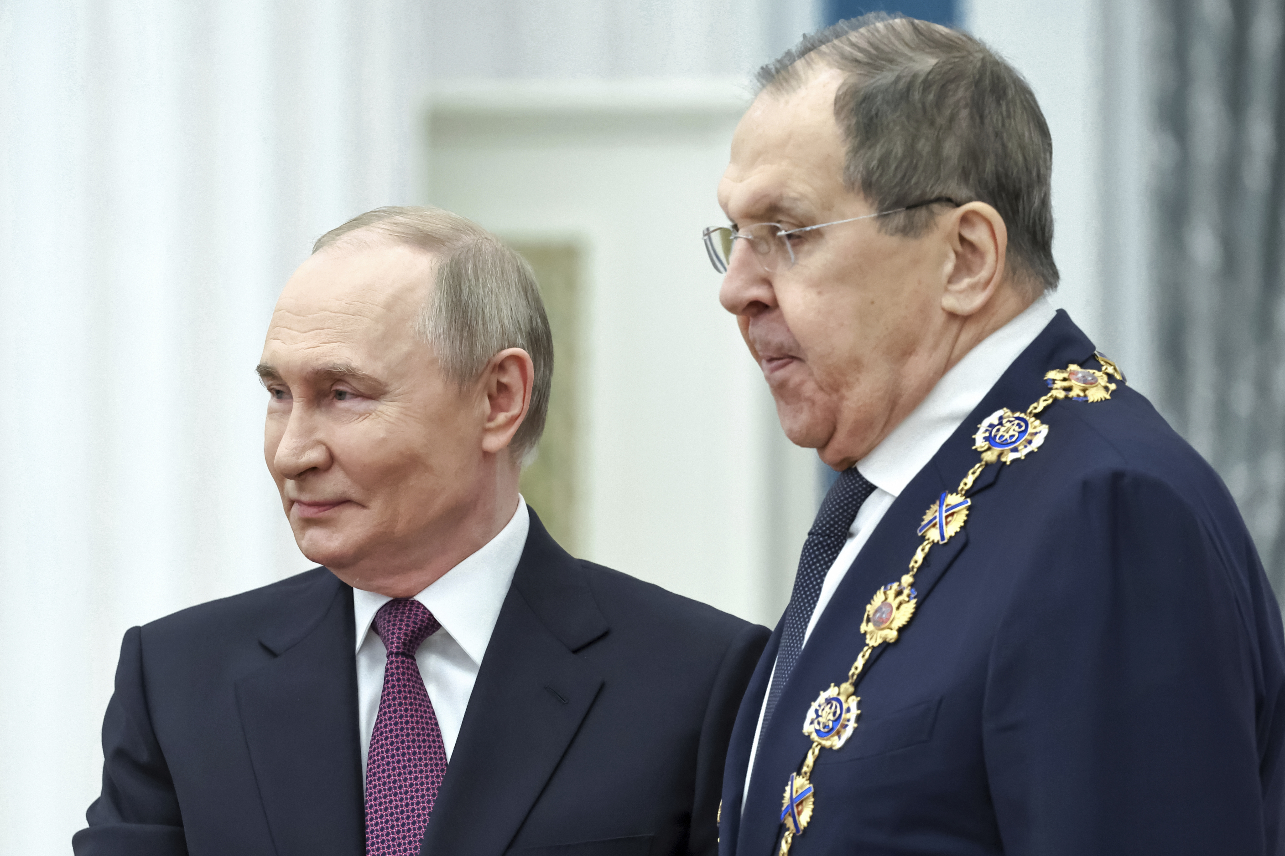 Russian President Vladimir Putin, left, awards Russian Foreign Minister Sergey Lavrov with the Order of St. Andrew the Apostle the First-Called during a ceremony to present highest state awards in the Catherine Hall of the Kremlin's Senate Palace in Moscow, Russia, Thursday, May 22, 2025. (Alexander Kazakov, Sputnik, Kremlin Pool Photo via AP)