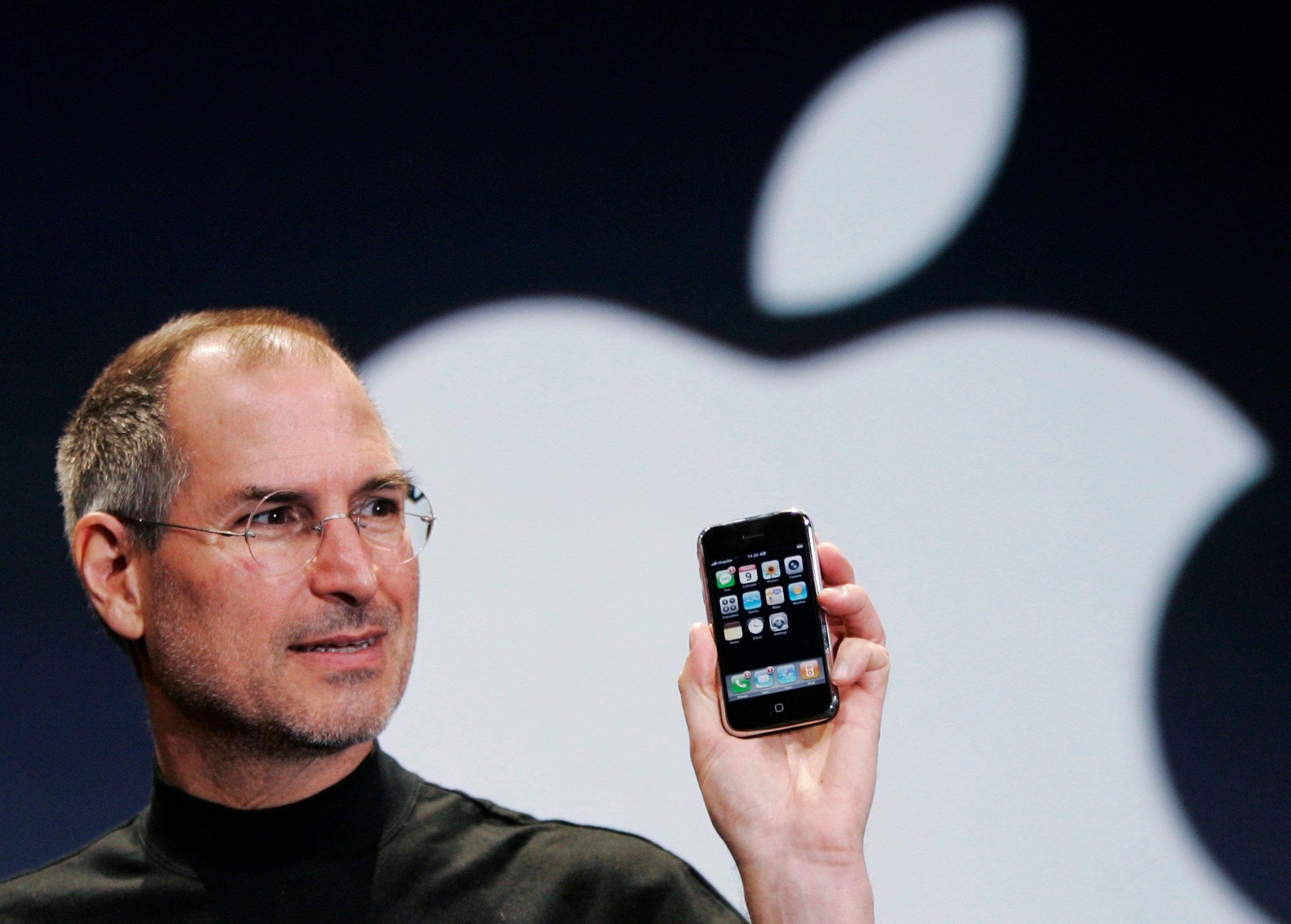 FILE- Apple CEO Steve Jobs holds up an Apple iPhone at the MacWorld Conference in San Francisco, in this Jan. 9, 2007 file photo.. (AP Photo/Paul Sakuma, File)