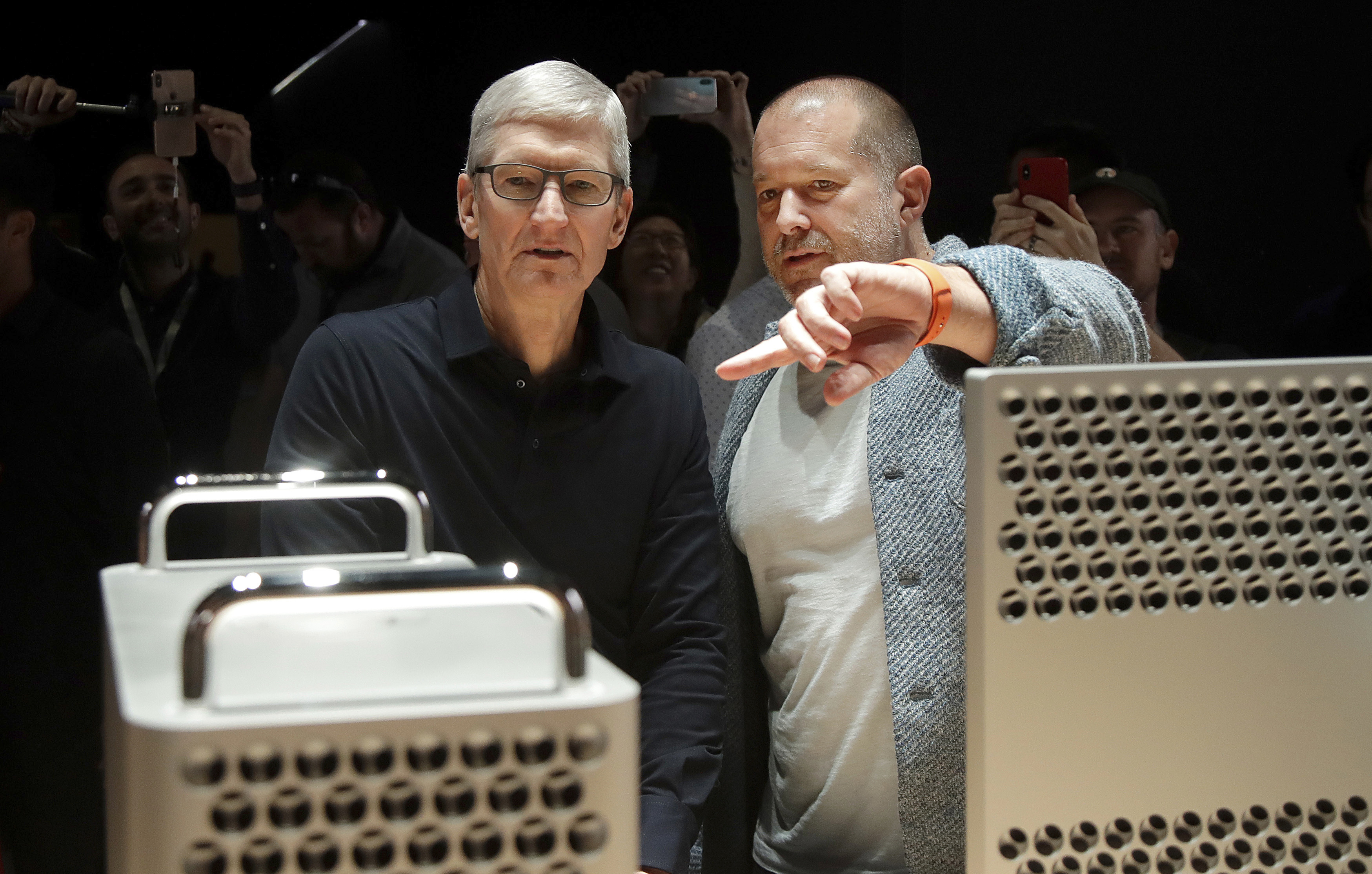 FILE - In this Monday, June 3, 2019 file photo, Apple CEO Tim Cook, left, and chief design officer Jonathan Ive look at the Mac Pro in the display room at the Apple Worldwide Developers Conference in San Jose, Calif. (AP Photo/Jeff Chiu, File)