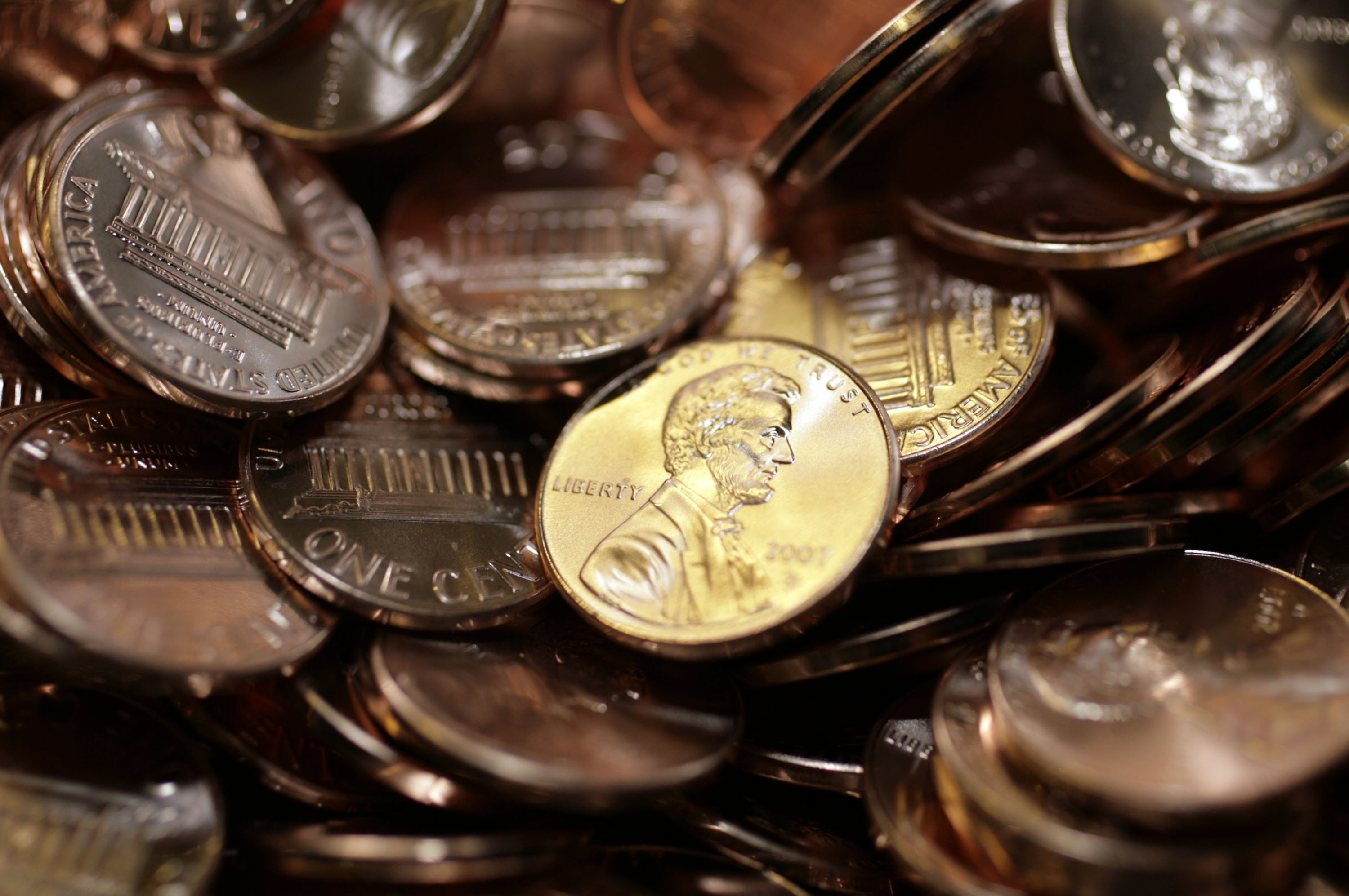 FILE - Freshly-made pennies sit in a bin at the U.S. Mint in Denver on Aug. 15, 2007. (AP Photo/David Zalubowski, File)