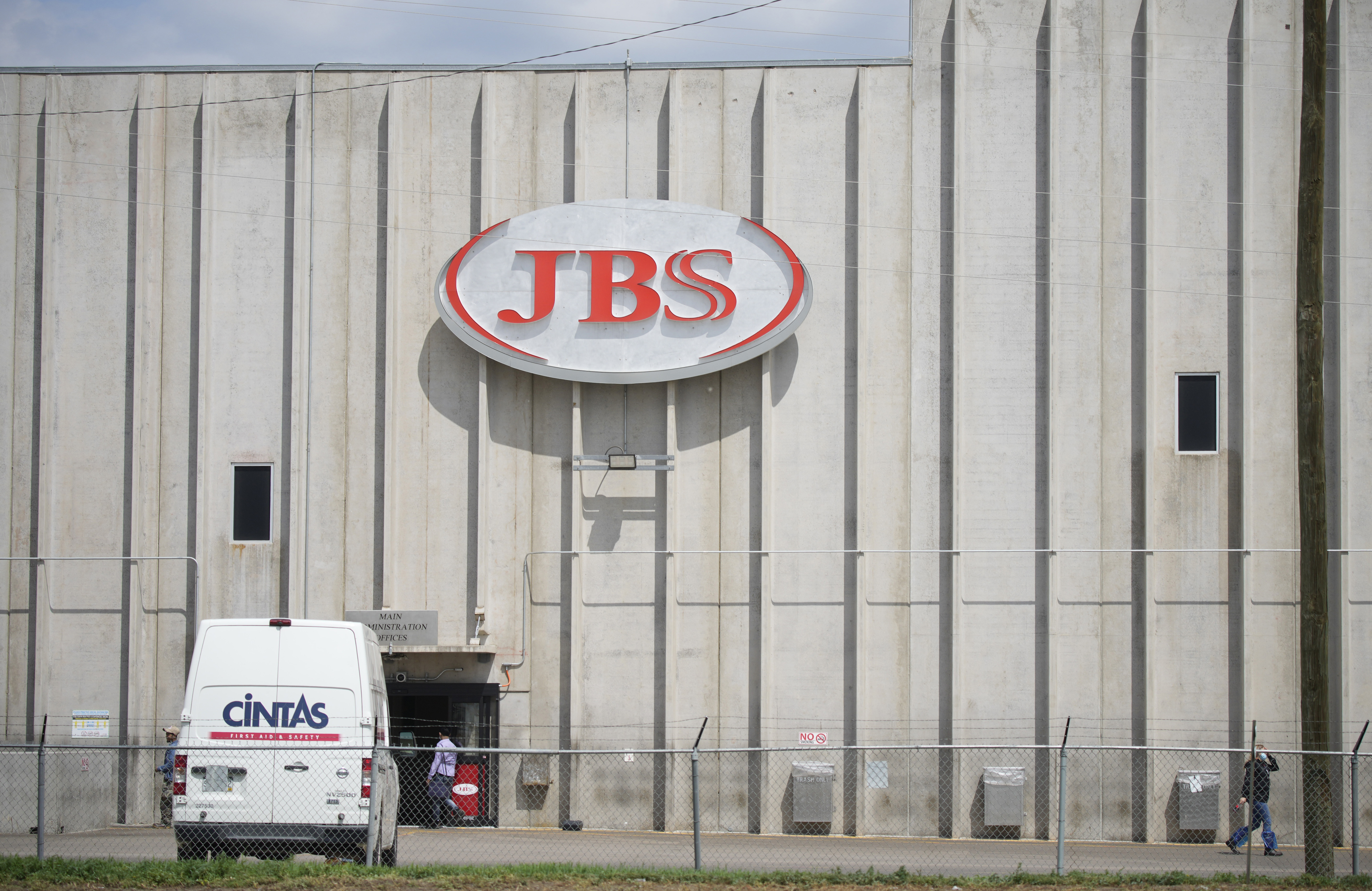 FILE - In this Friday, July 223, 2021, photograph, employees move into an entrance to the JBS meat processing plant in Greeley, Colo. (AP Photo/David Zalubowski, File)