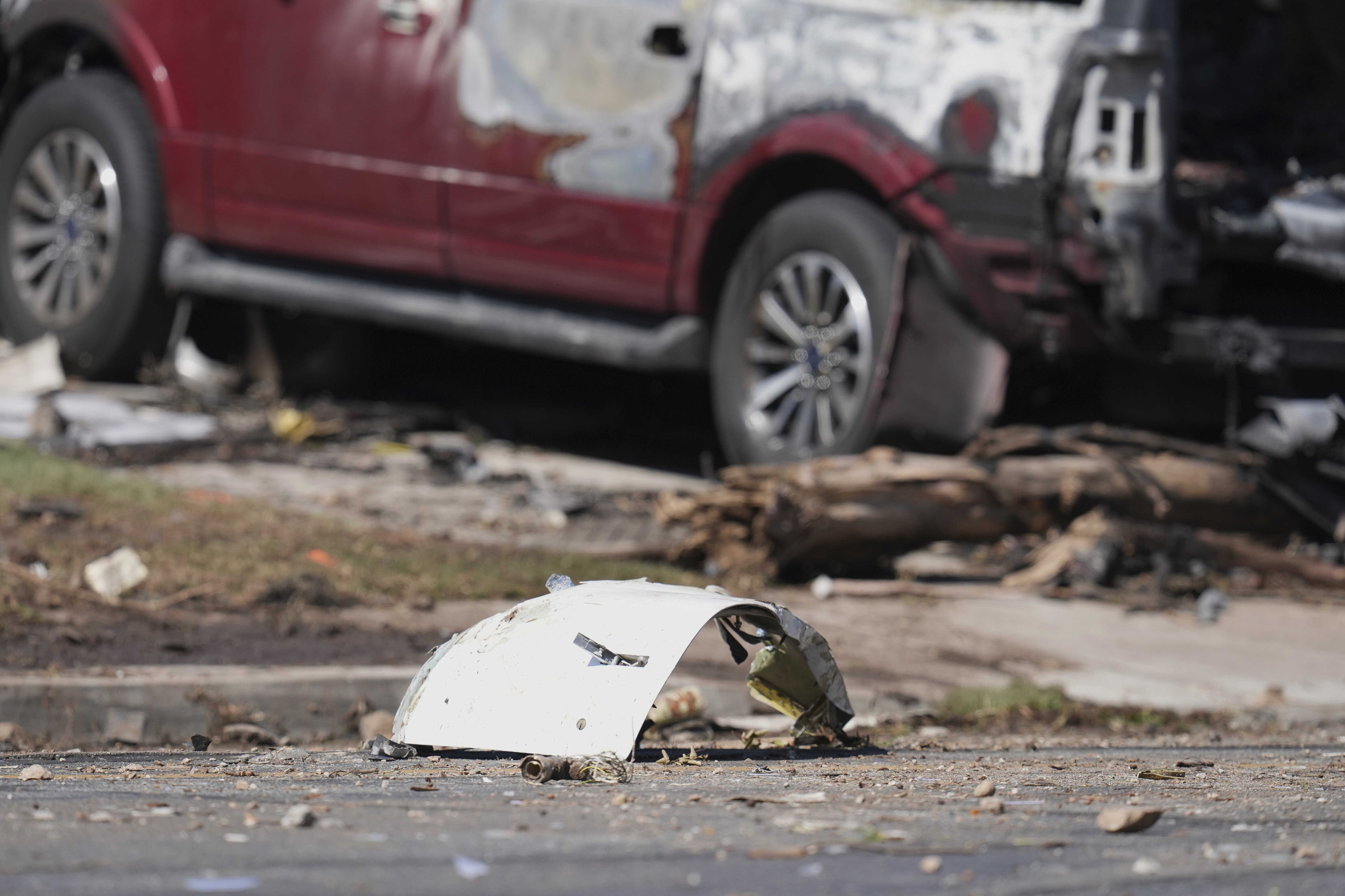 Debris covers the ground after a small plane crashed into a San Diego neighborhood earlier, setting several homes on fire and forcing evacuations along several blocks early Thursday, May 22, 2025. (AP Photo/Gregory Bull)