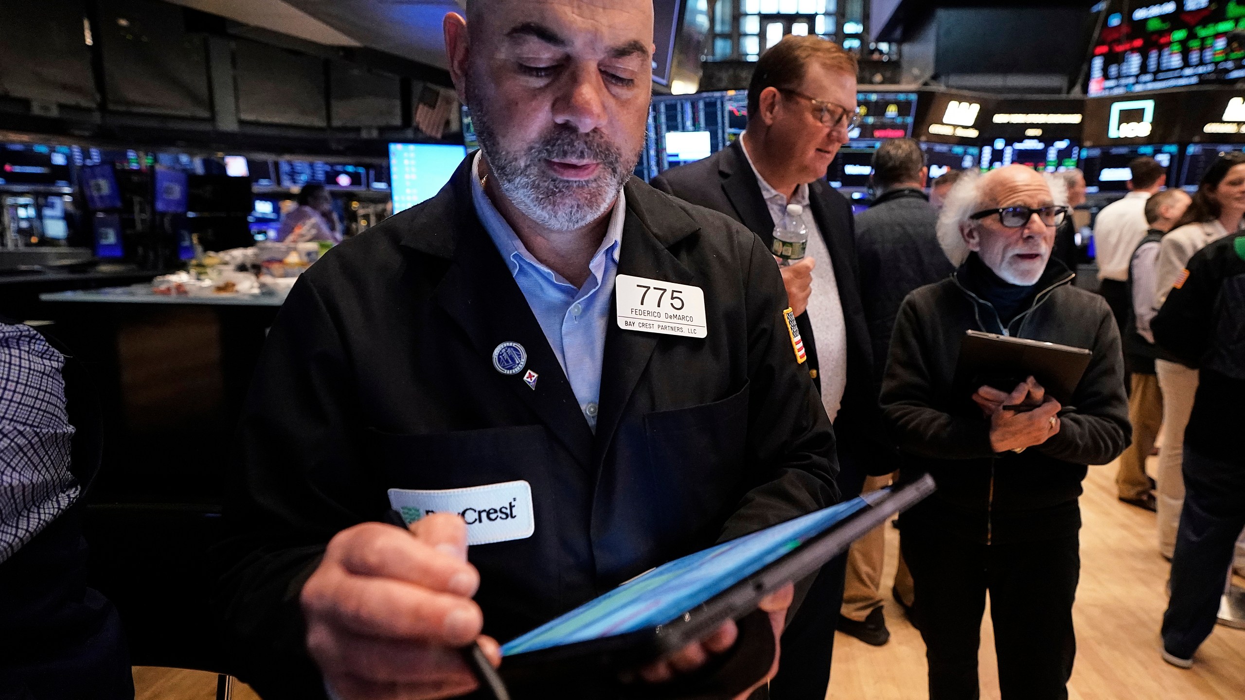 Traders Fred Demarco, left, and Peter Tuchman, right, work on the floor of the New York Stock Exchange, Tuesday, May 20, 2025. (AP Photo/Richard Drew)