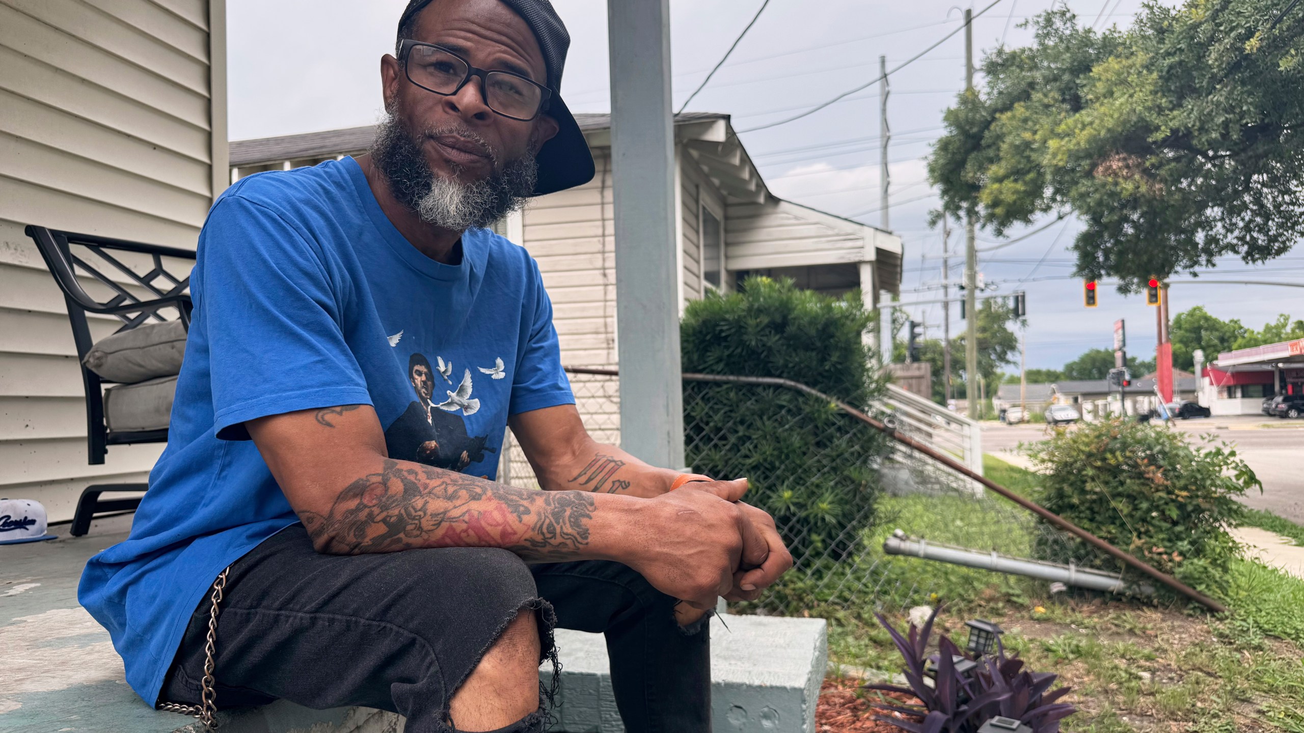 Mario Westbrook sits on his porch, May 21, 2025, in New Orleans East, where he says the community has long had negative experiences with law enforcement. (AP Photo/Jack Brook)