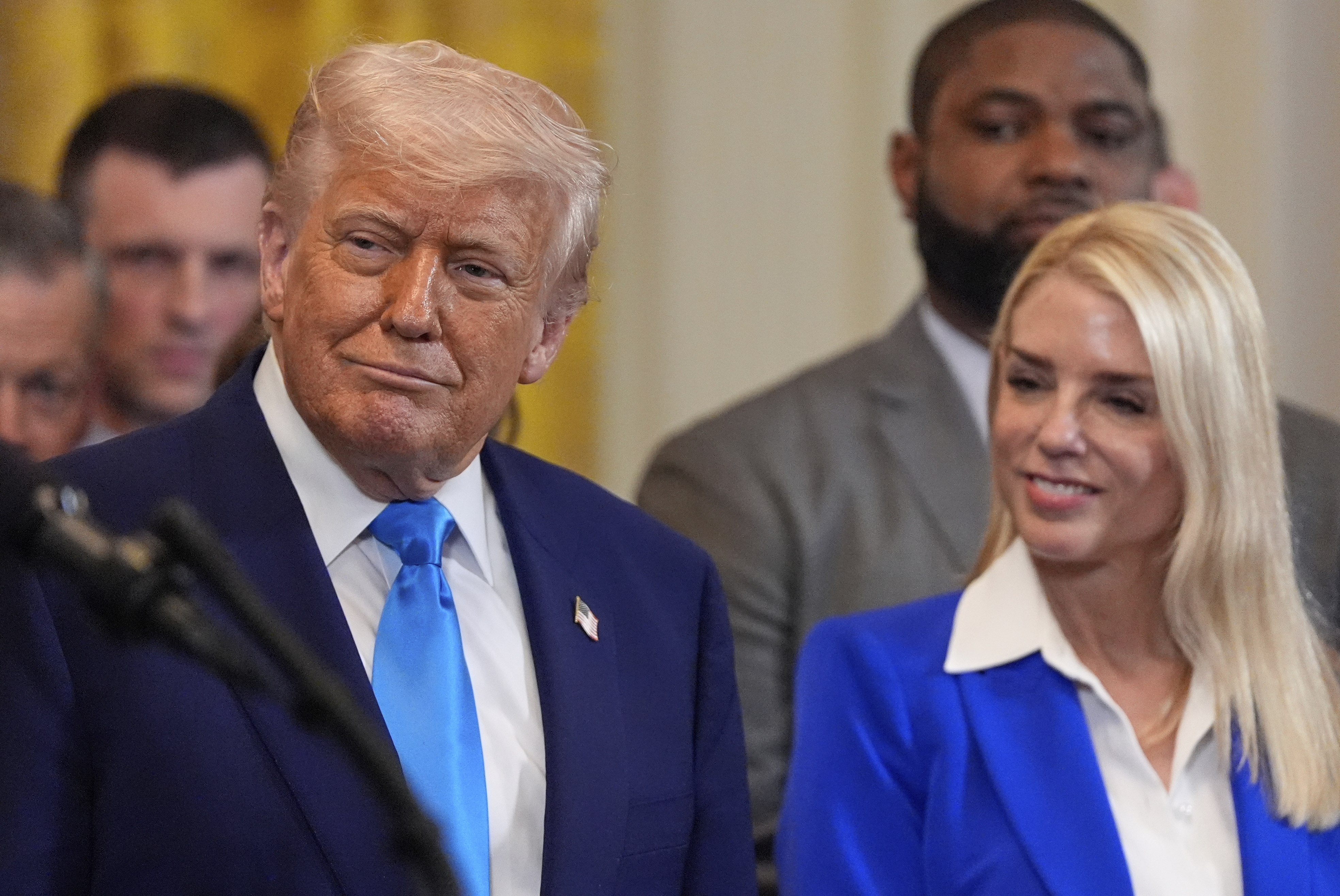 President Donald Trump and Attorney General Pam Bondi listen as head coach Todd Golden speaks as Trump hosts the 2025 NCAA Champion, University of Florida men's basketball team in the East Room of the White House, Wednesday, May 21, 2025, in Washington. (AP Photo/Julia Demaree Nikhinson)