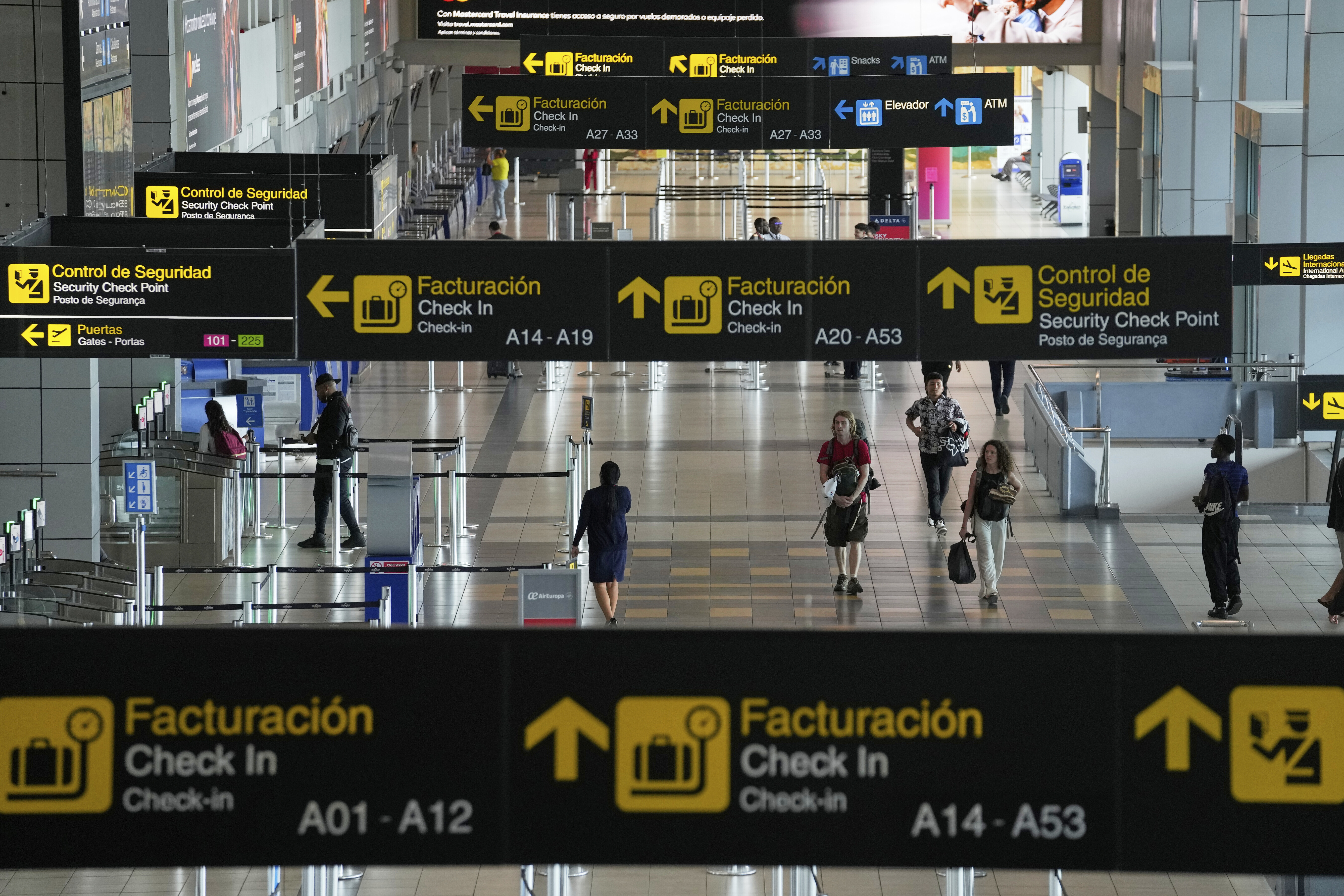 Travelers walk through Tocumen International Airport in Panama City, Thursday, May 22, 2025, as Panama and Venezuela prepare to resume commercial flights nearly a year after suspending them when Panamanian President Jose Raul Mulino refused to recognize the re-election of Venezuelan President Nicolas Maduro. (AP Photo/Matias Delacroix)