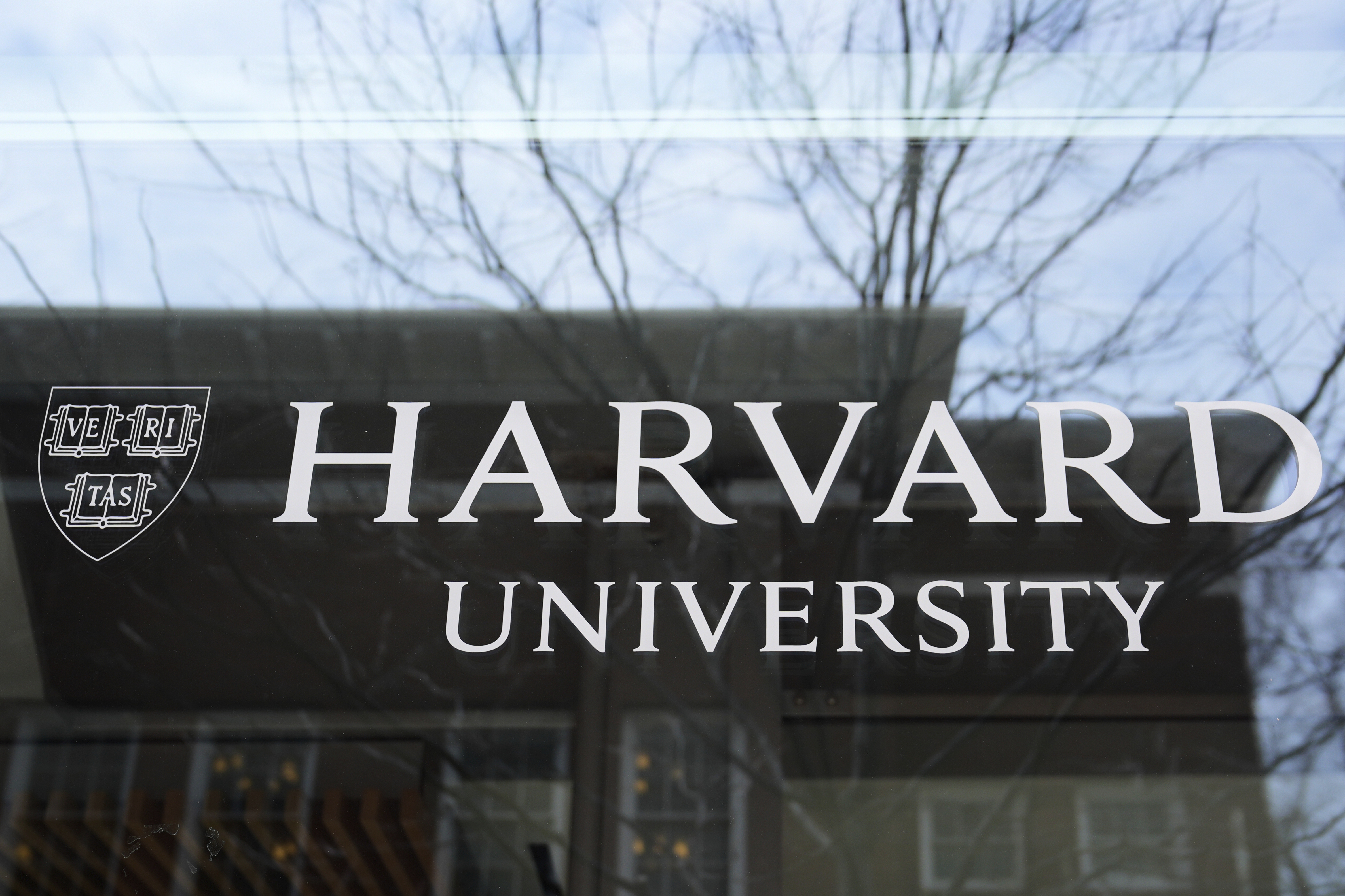 FILE - The Harvard University logo is displayed on a building at the school, Tuesday, April 15, 2025, in Cambridge, Mass. (AP Photo/Charles Krupa, File)