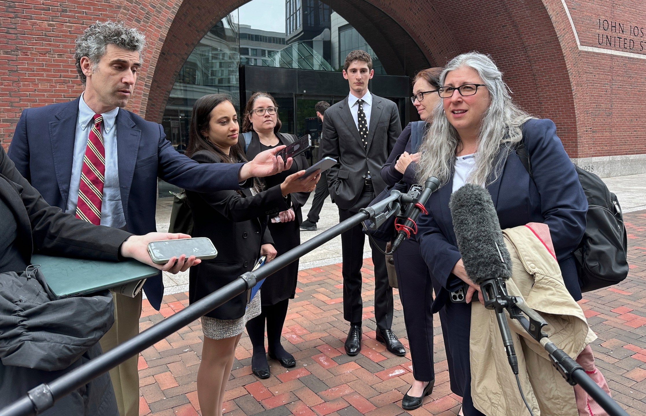 Lawyers for several individuals facing deportation speak to the media Wednesday, May 21, 2025, in Boston, after a federal judge ruled the White House violated a court order on deportations to third countries with a flight linked to the chaotic African nation of South Sudan. (AP Photo/Michael Casey)