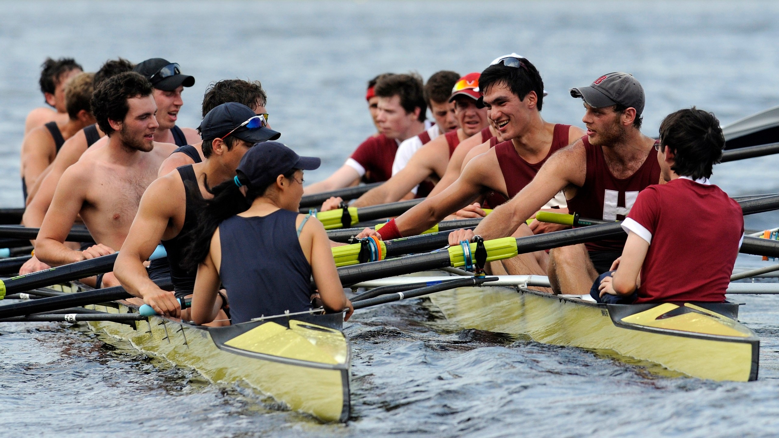 FILE — Members of Yale crew, left, and Harvard crew, right, greet one another after the four-mile course along the Thames River for the 146th Harvard-Yale Regatta, in New London, Conn., Saturday, May 28, 2011. (AP Photo/Jessica Hill, File)