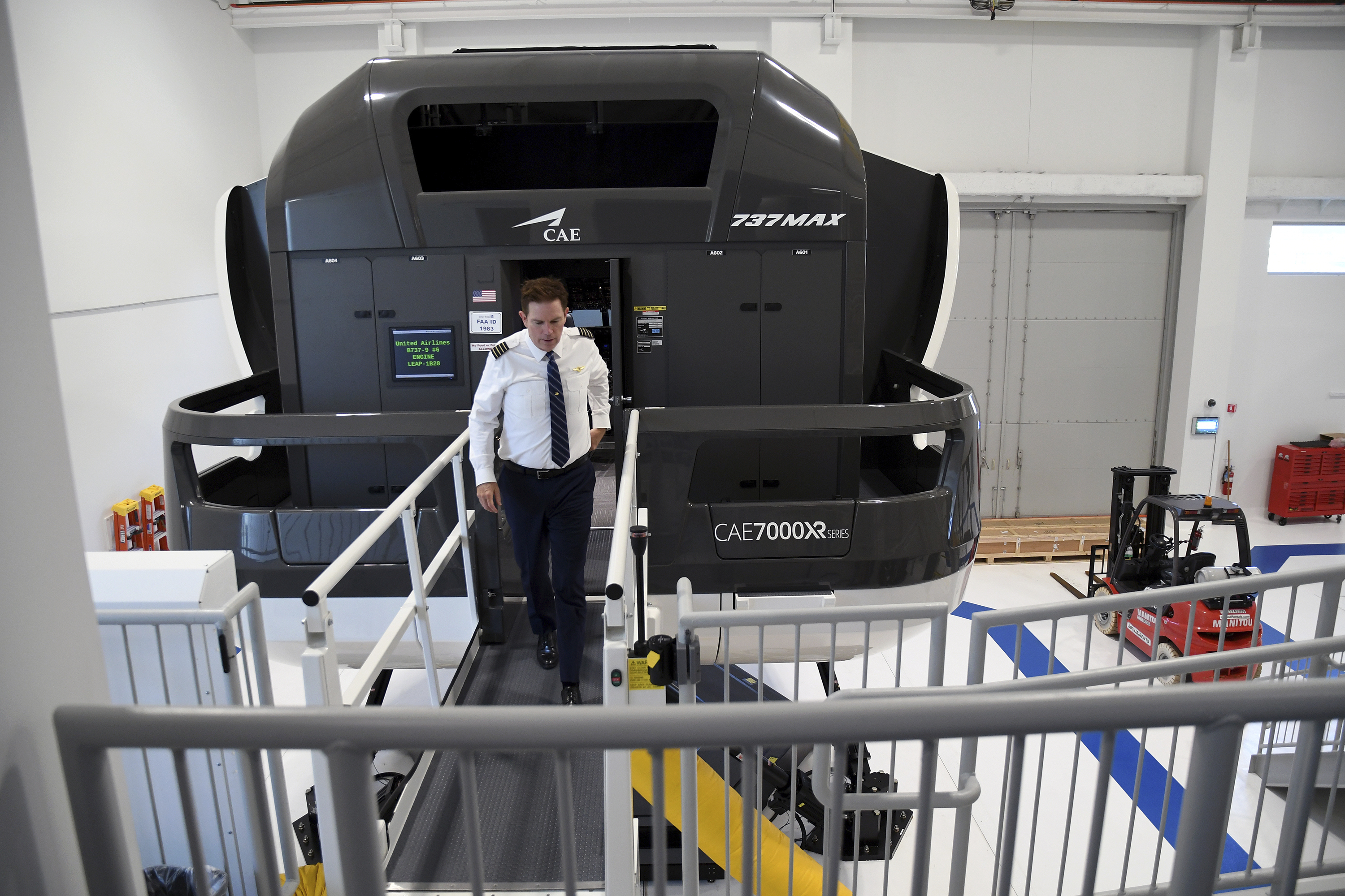 Capt. Miles Morgan, managing director of flight training for United Airlines, exits a simulator at the company's training campus in Denver, Friday, May 16, 2025. (AP Photo/Thomas Peipert)