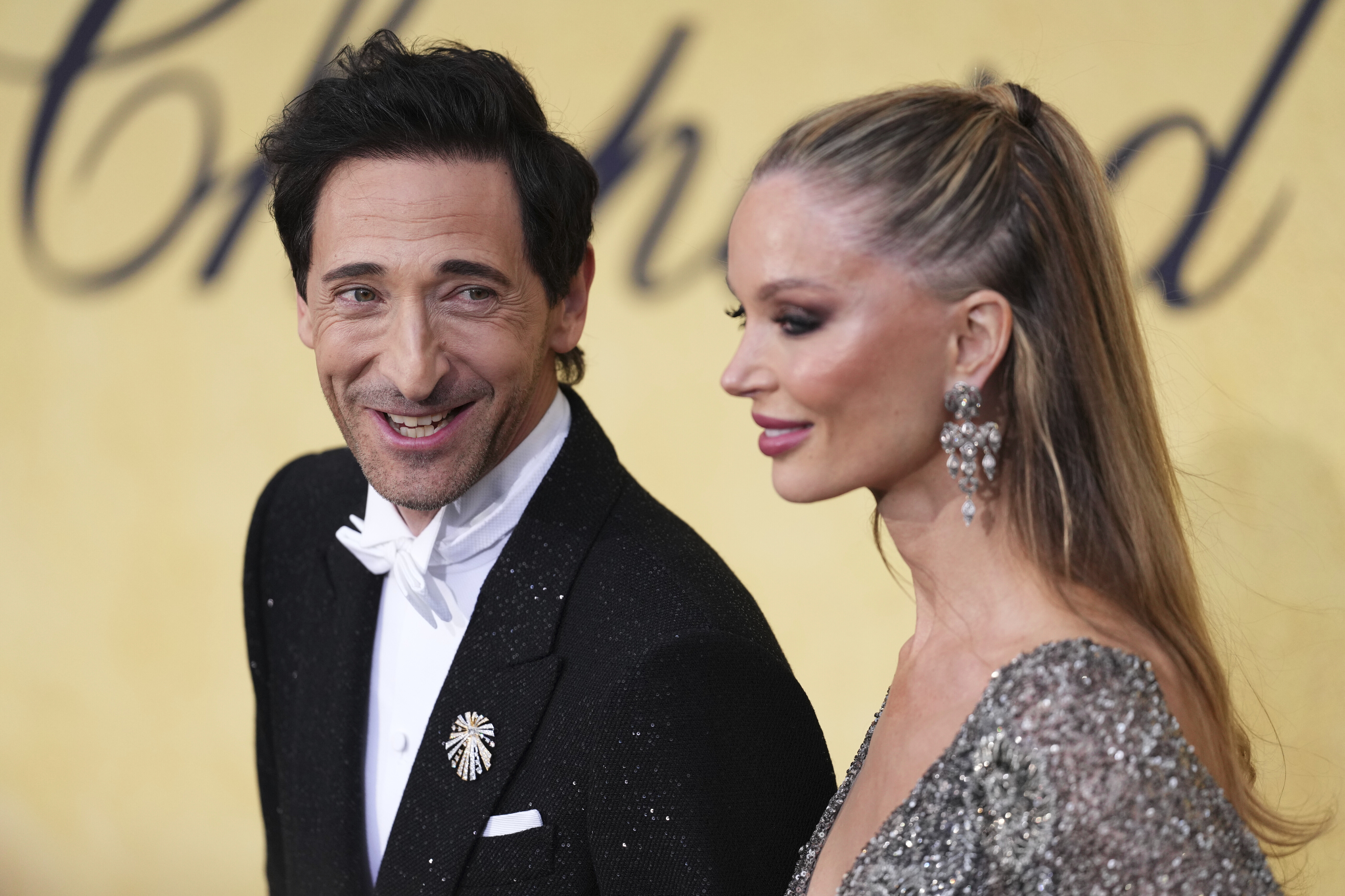 Adrien Brody, left, and Georgina Chapman pose for photographers upon arrival at the amfAR Cinema Against AIDS benefit at the Hotel du Cap-Eden-Roc, during the 78th Cannes international film festival, Cap d'Antibes, southern France, Thursday, May 22, 2025. (Photo by Scott A Garfitt/Invision/AP)