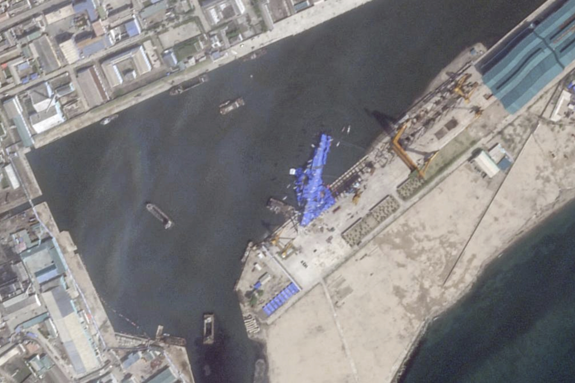 This satellite image from Planet Labs PBC shows a blue tarp covering a North Korean destroyer after it suffered a failed launch while it was being put to sea in Chongjin, North Korea, Friday, May 23, 2025. (Planet Labs PBC via AP)