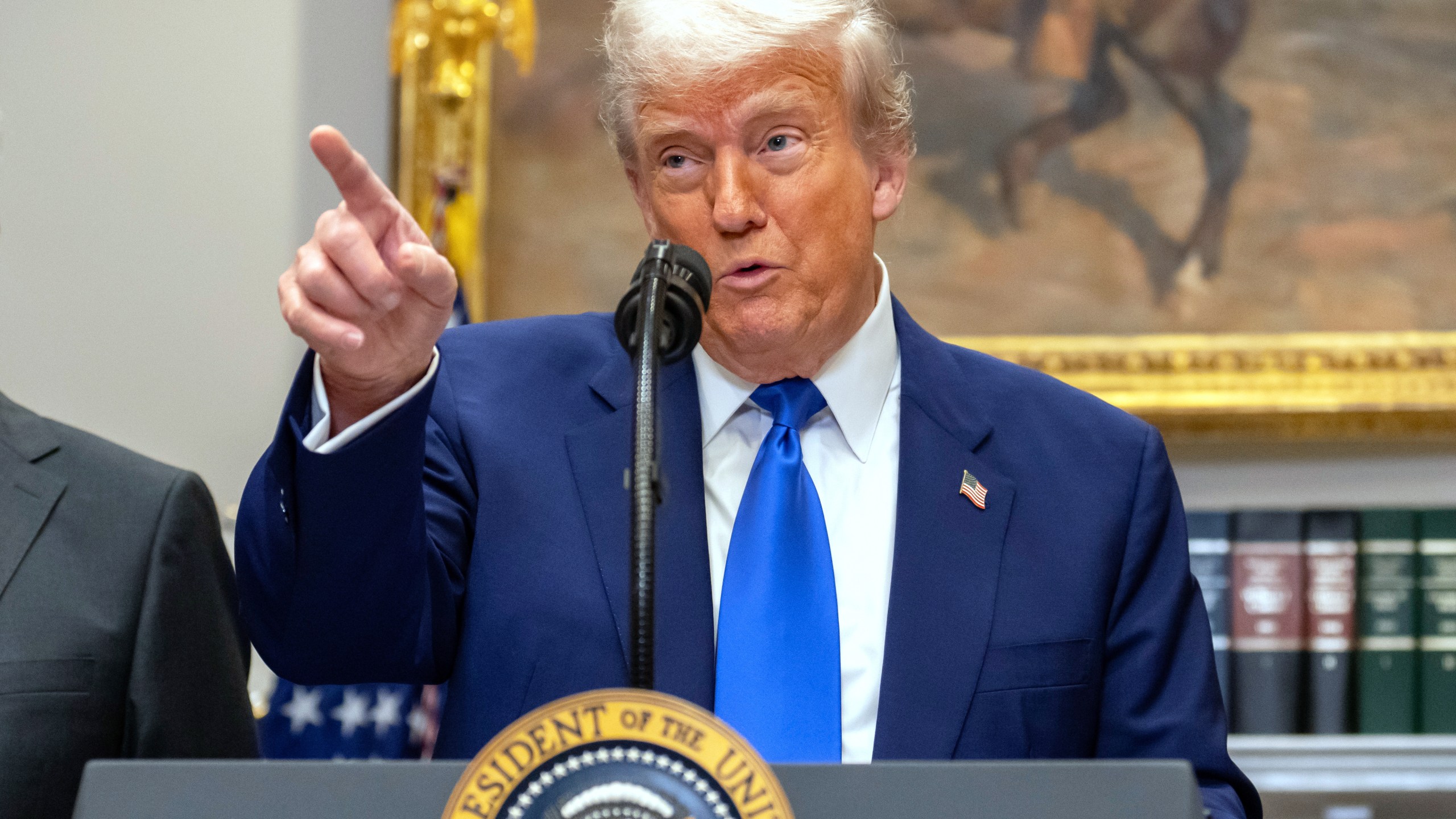 President Donald Trump gestures while answering a reporter's question during an event in the Roosevelt Room at the White House, Monday, May 12, 2025, in Washington. (AP Photo/Mark Schiefelbein)