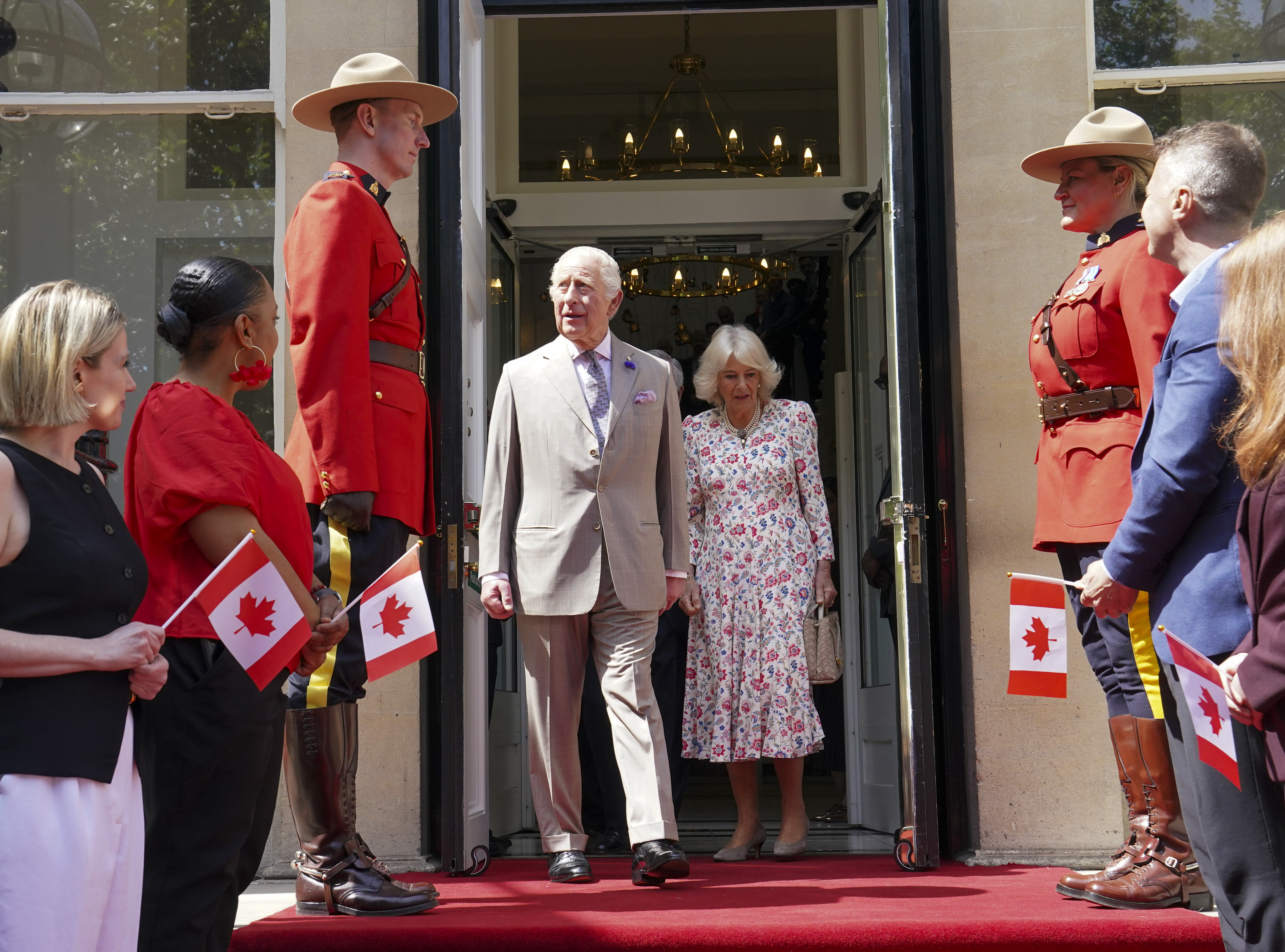 Britain's King Charles, centre left, and Queen Camilla leave after visiting the Canada House Trafalgar Square, in London, Tuesday, May 20, 2025 to mark 100 years since it opened in June 1925. (Arthur Edwards/Pool via AP)