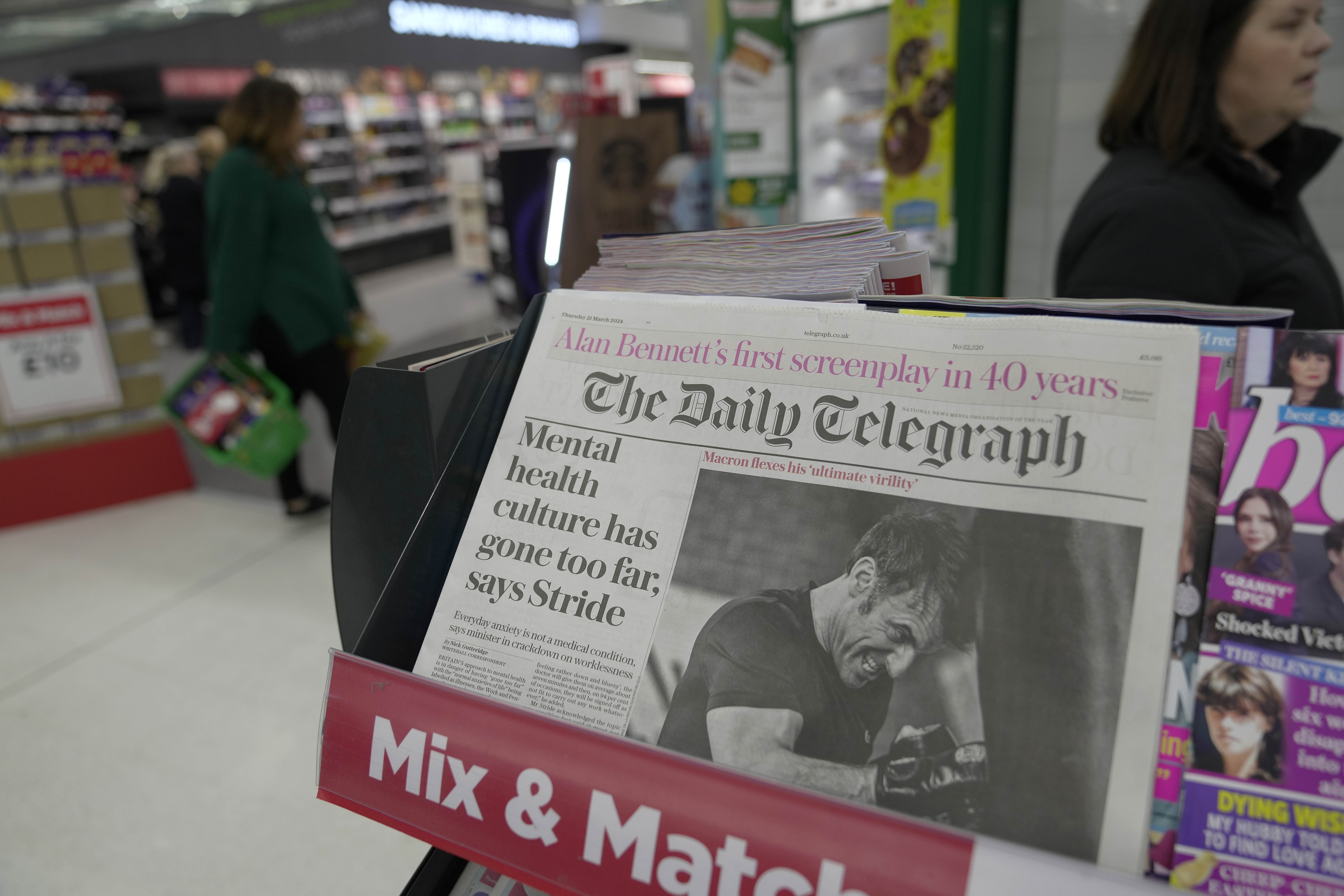 FILE -The Daily Telegraph newspaper with the front page of French President Emanuel Macron is seen at a supermarket in London, March 21, 2024. (AP Photo/Kin Cheung, File)
