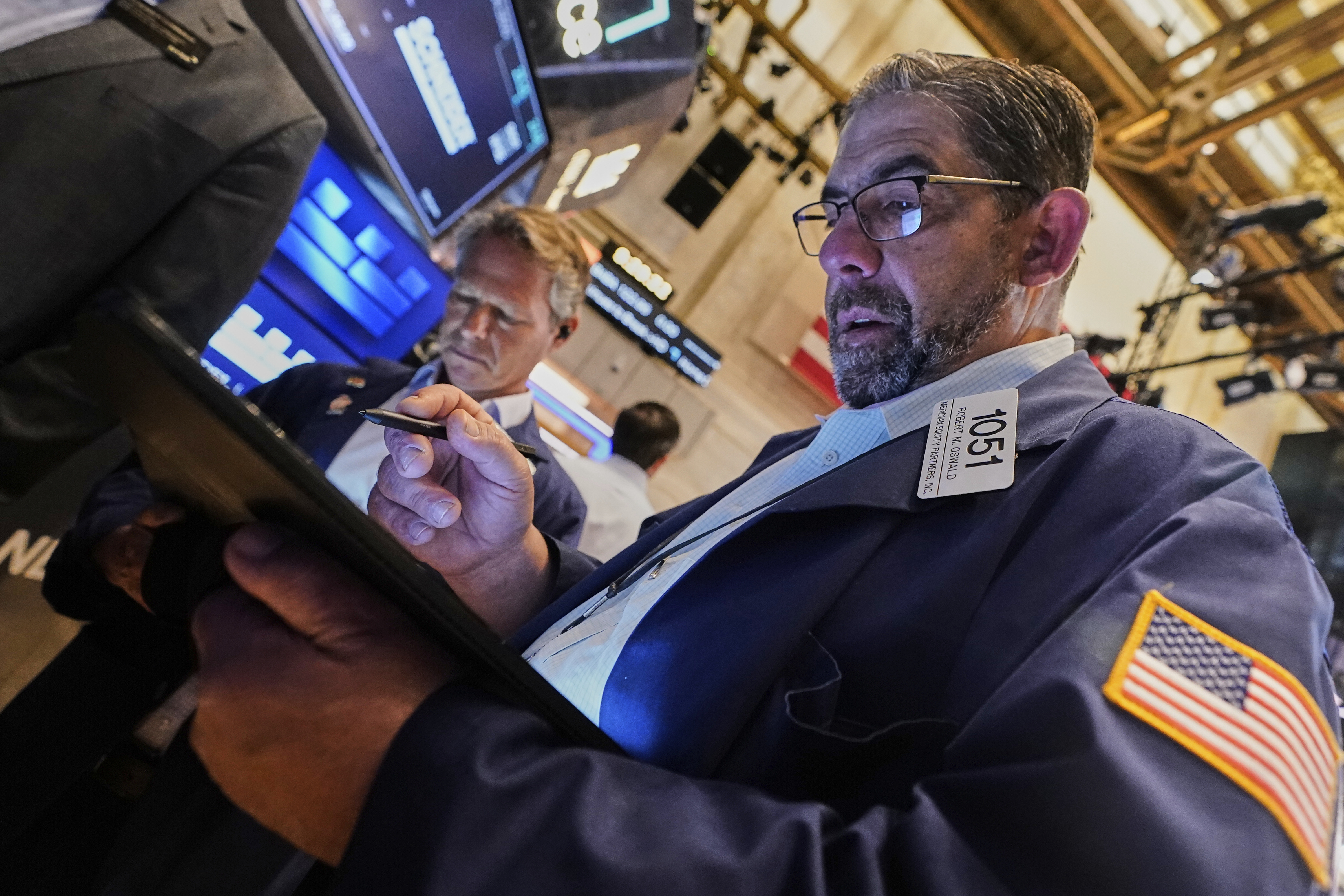 Trader Robert Oswald, right, works on the floor of the New York Stock Exchange, Tuesday, May 20, 2025. (AP Photo/Richard Drew)