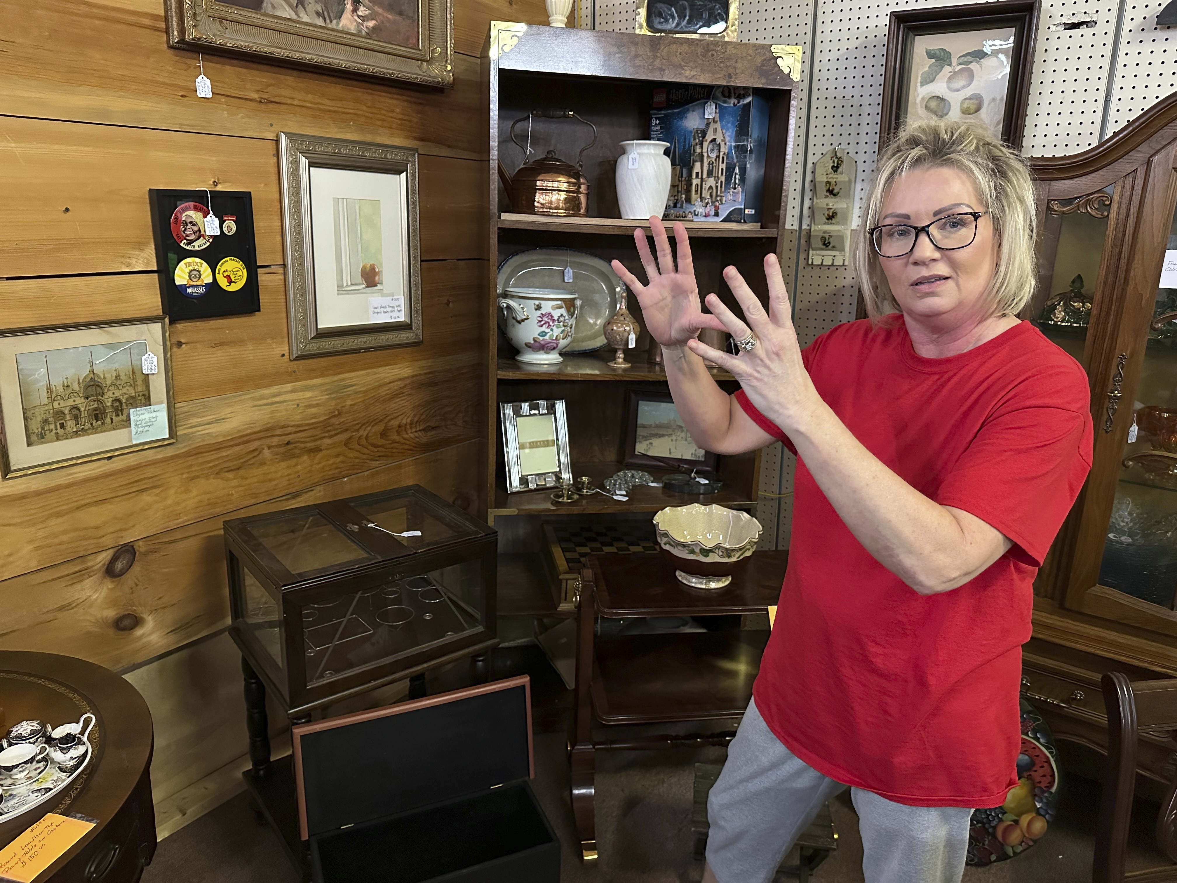 Michelle Hackworth discusses U.S. politics standing in her Paintsville, Ky., antiques store, Friday, May 16, 2025. (AP Photo/Bill Barrow)