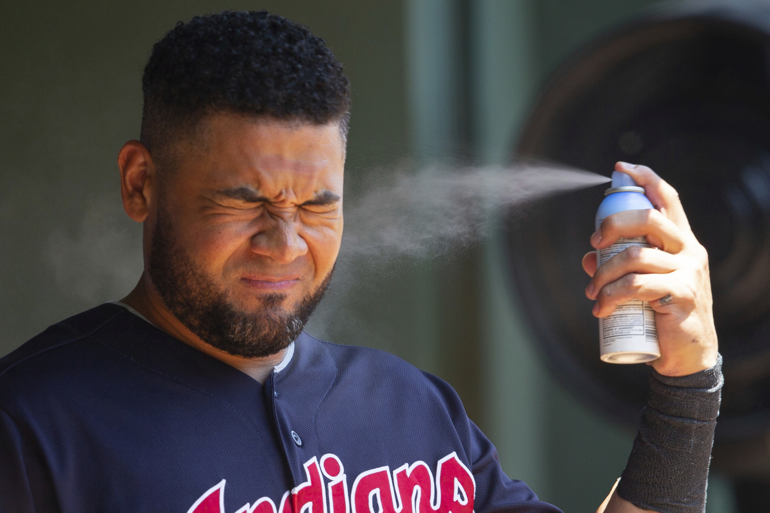 FILE - Cleveland Indians right fielder Melky Cabrera sprays sunscreen before a baseball game against the Texas Rangers, Sunday, July 22, 2018, in Arlington, Texas. (AP Photo/Sam Hodde, File)