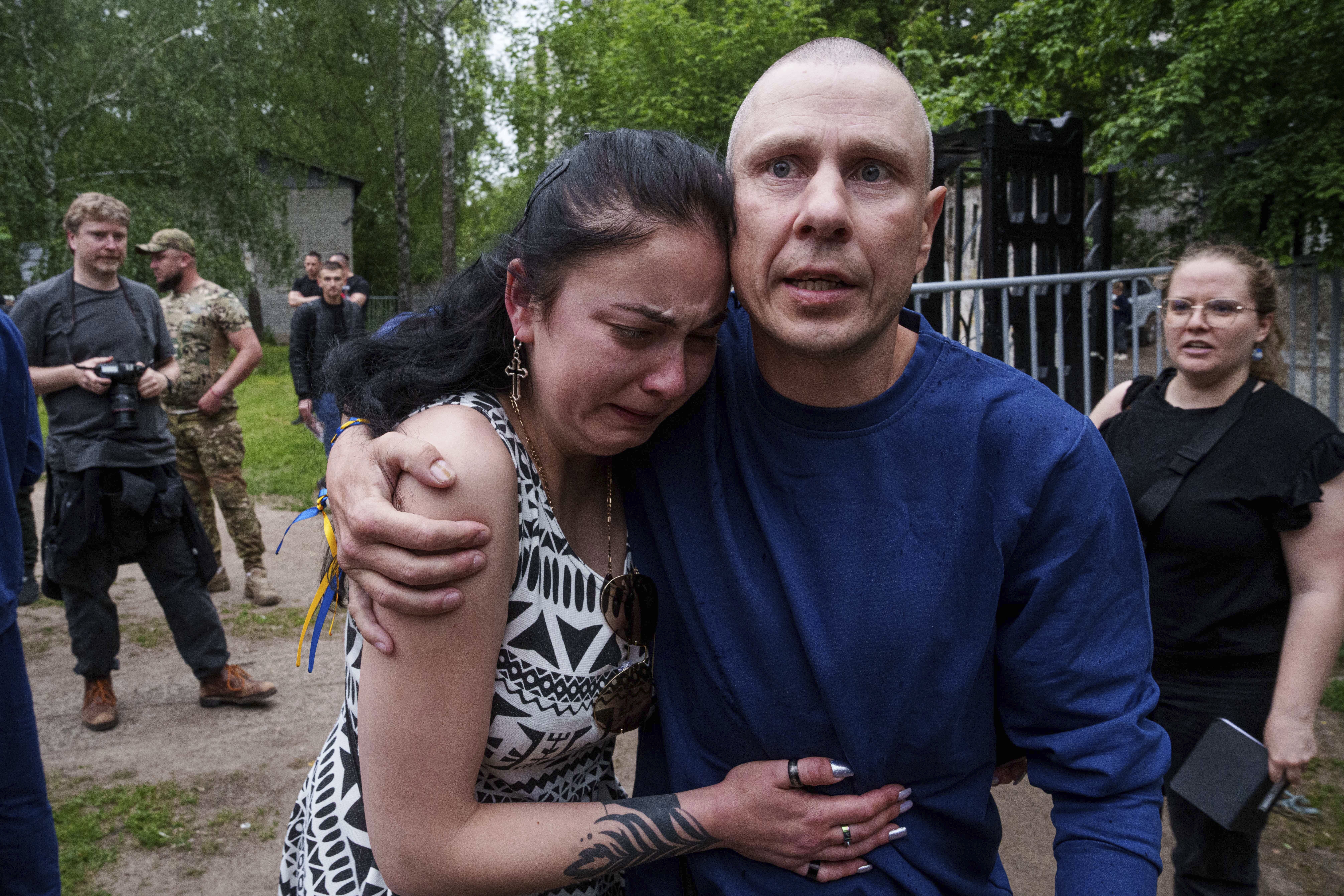 A Ukrainian soldier hugs a woman after returning from captivity during a POWs exchange between Russia and Ukraine, in Chernyhiv region, Ukraine, Saturday, May 24, 2025. (AP Photo/Evgeniy Maloletka)