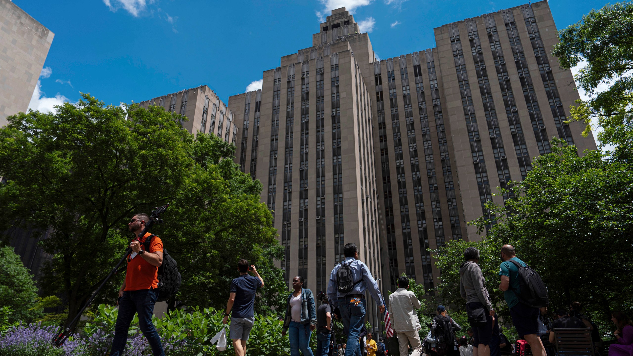 FILE - People walk by the Manhattan Criminal Court building, Wednesday, May 29, 2024, in New York. (AP Photo/Julia Nikhinson, File)