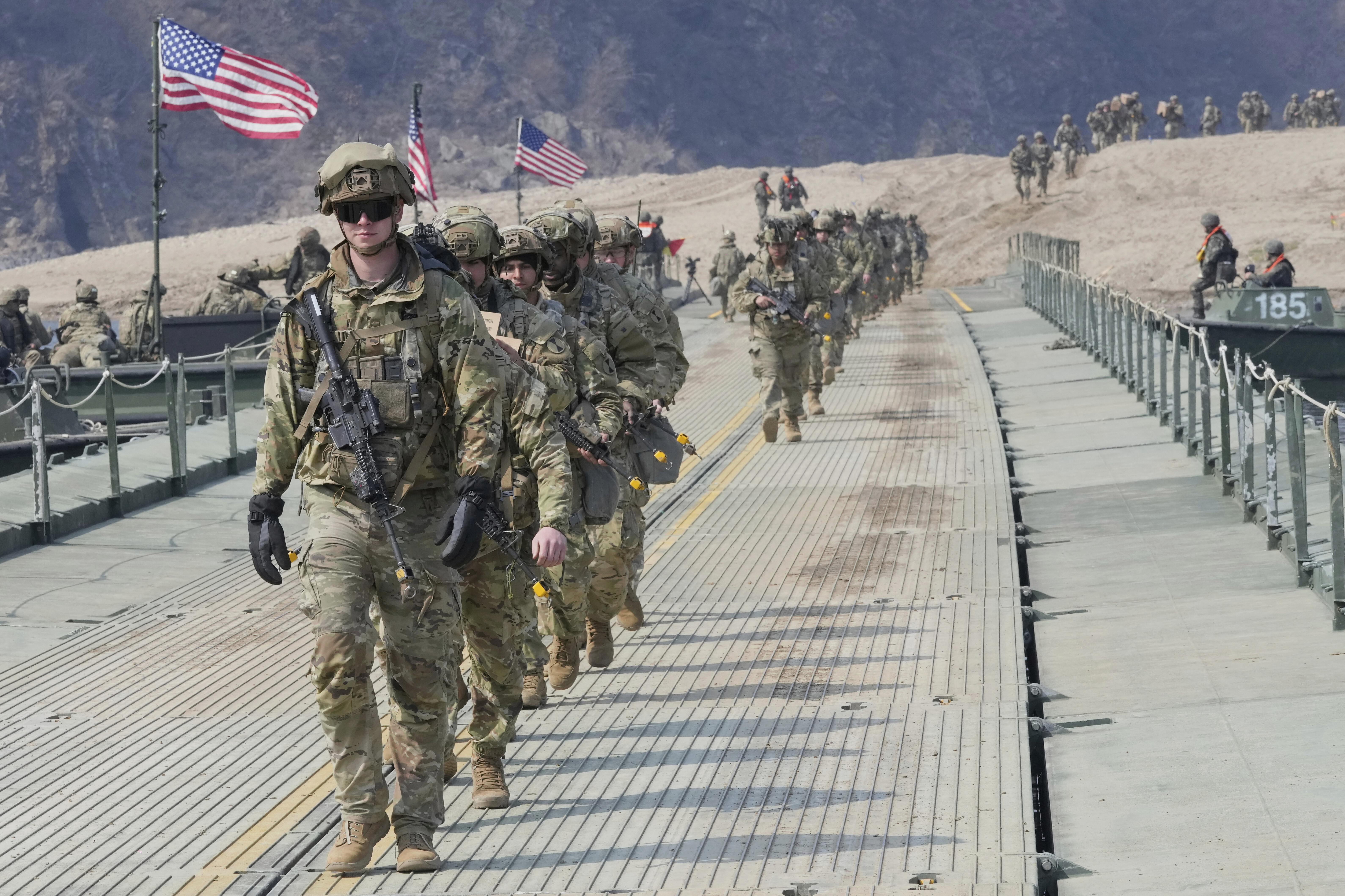FILE - U.S. Army soldiers cross a floating bridge on the Imjin River during a joint river-crossing exercise between South Korea and the United States as a part of the Freedom Shield military exercise in Yeoncheon, South Korea, March 20, 2025. (AP Photo/Ahn Young-joon, File)