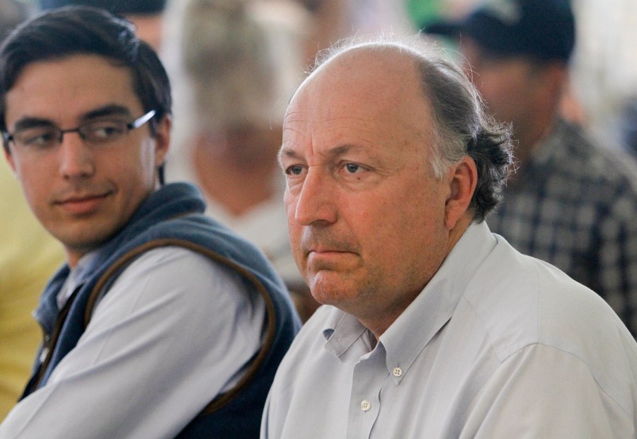 FILE - Tonalist trainer, Christophe Clement, right, listens during the draw for the Belmont Stakes horse race, Tuesday, June 3, 2014, at Belmont Park in Elmont, N.Y. (AP Photo/Garry Jones, File)