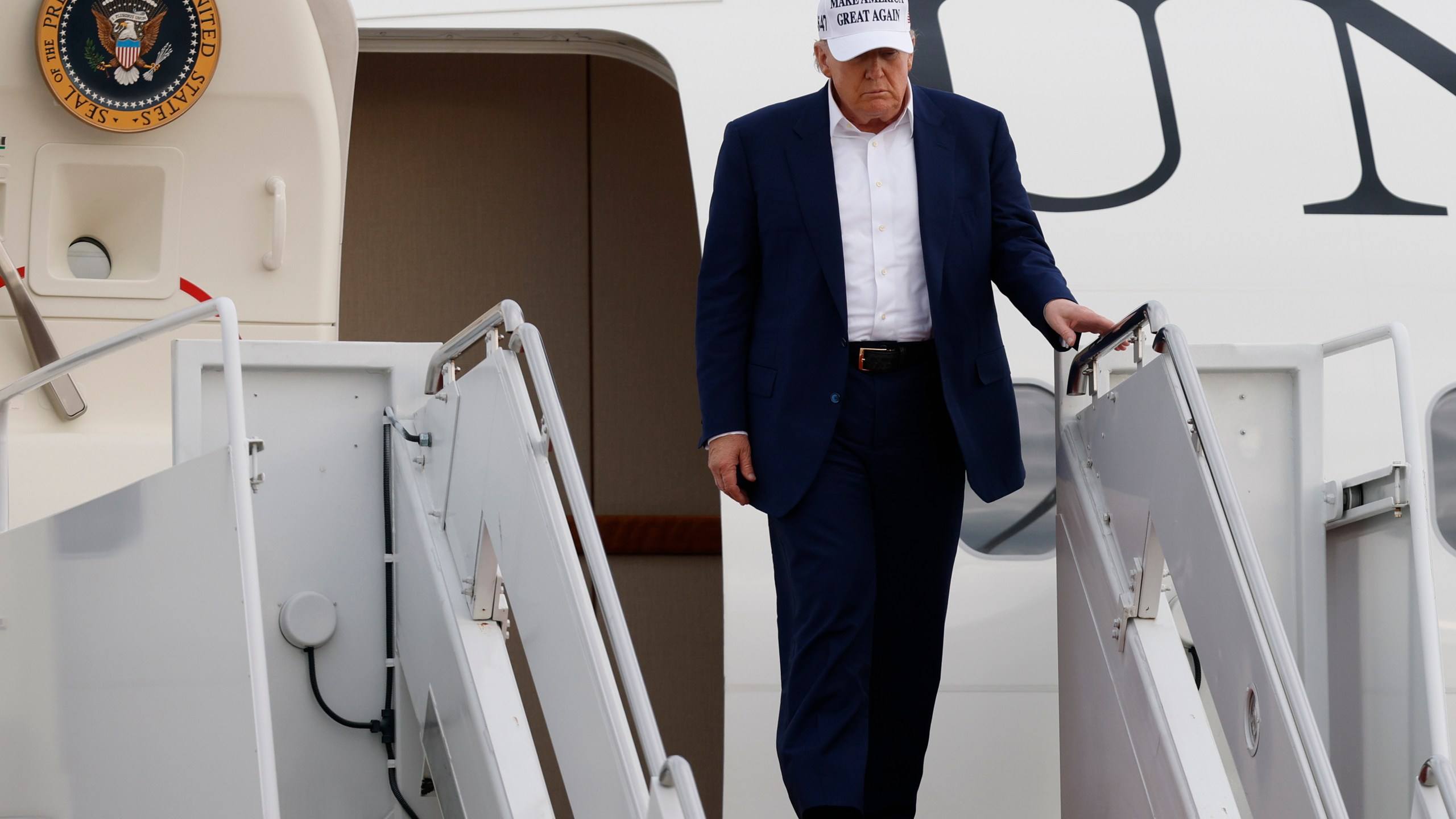President Donald Trump walks down the stairs of Air Force One upon his arrival at Joint Base Andrews, Md., Sunday, May 25, 2025. (AP Photo/Luis M. Alvarez)