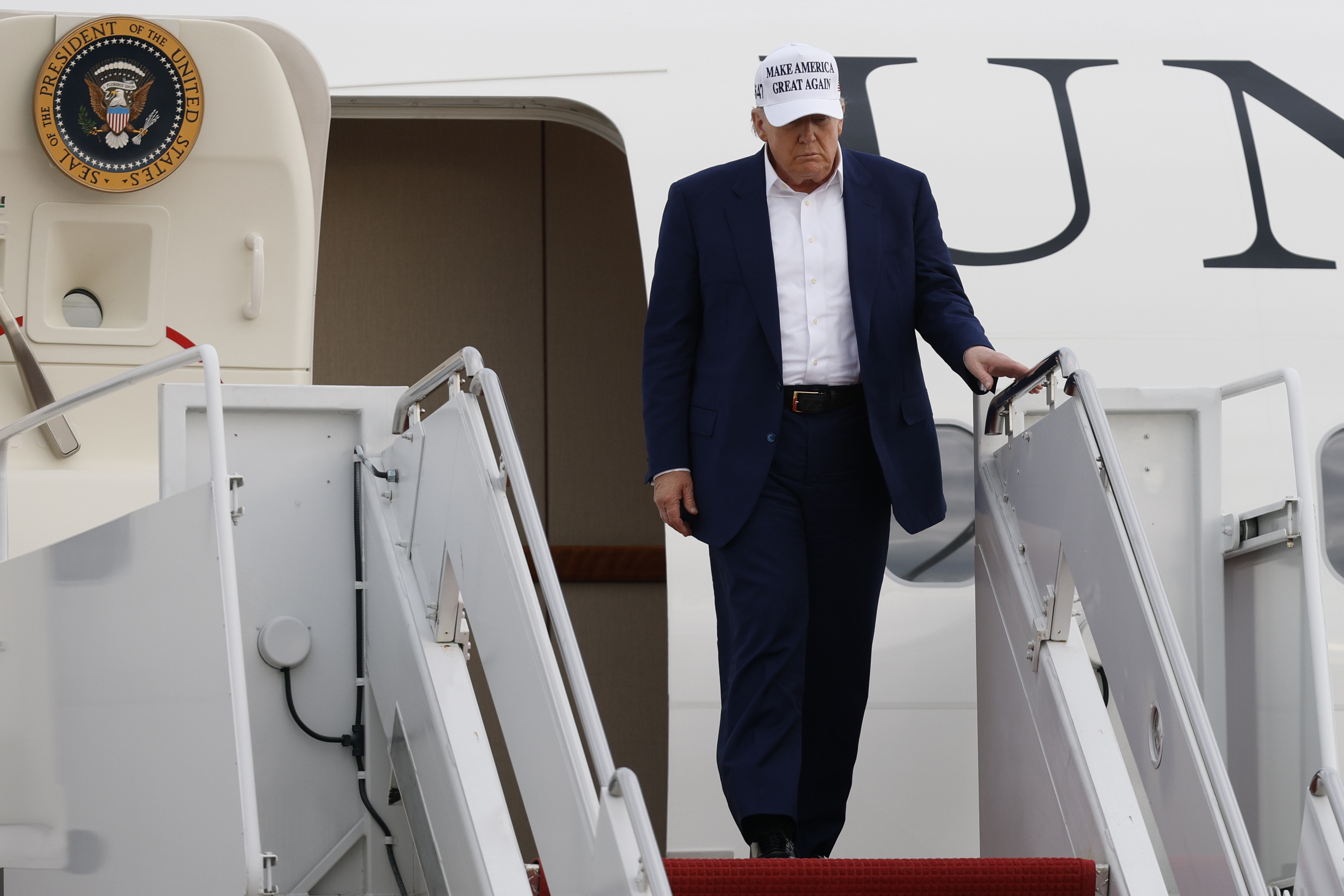President Donald Trump walks down the stairs of Air Force One upon his arrival at Joint Base Andrews, Md., Sunday, May 25, 2025. (AP Photo/Luis M. Alvarez)