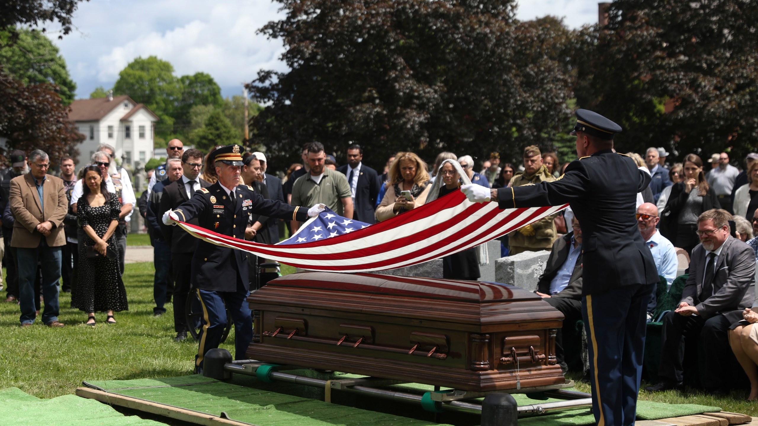 An American flag is folded during the interment for World War II U.S. Army Air Forces Staff Sgt. Eugene Darrigan at the cemetery behind St. Mary's church, Saturday, May 24, 2025, in Wappingers Falls, N.Y. Darrigan was buried in his hometown after his remains were recovered from a World War II bomber that crashed into the water off the coast of New Guinea on March 11, 1944. (AP Photo/Heather Khalifa)