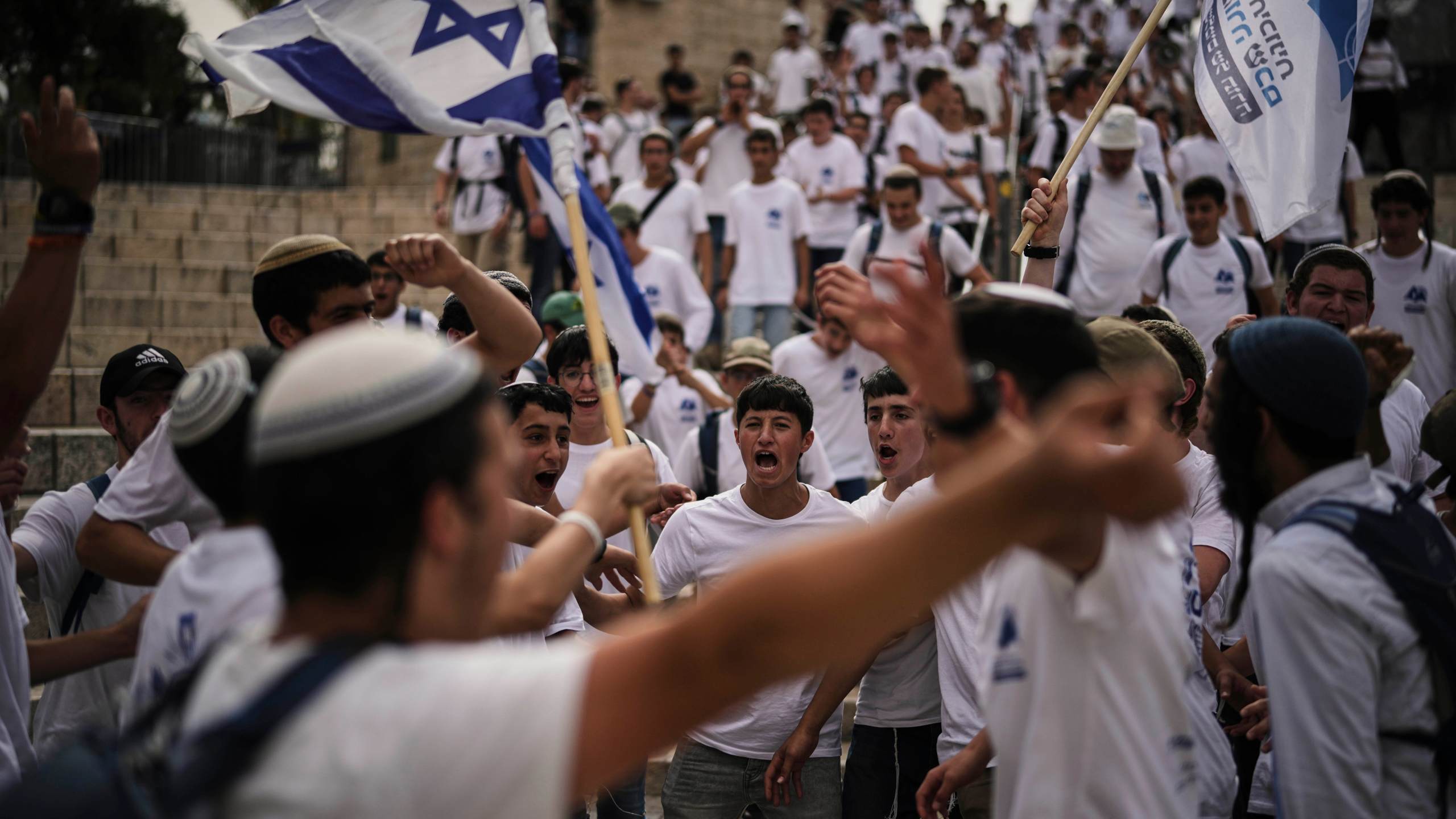 Israelis wave national flags during a march marking Jerusalem Day, an Israeli holiday celebrating the capture of east Jerusalem in the 1967 Mideast war, in Jerusalem's Old City, Monday, May 26, 2025. (AP Photo/Leo Correa)