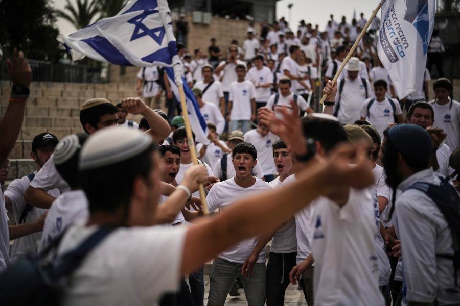 Israelis wave national flags during a march marking Jerusalem Day, an Israeli holiday celebrating the capture of east Jerusalem in the 1967 Mideast war, in Jerusalem's Old City, Monday, May 26, 2025. (AP Photo/Leo Correa)