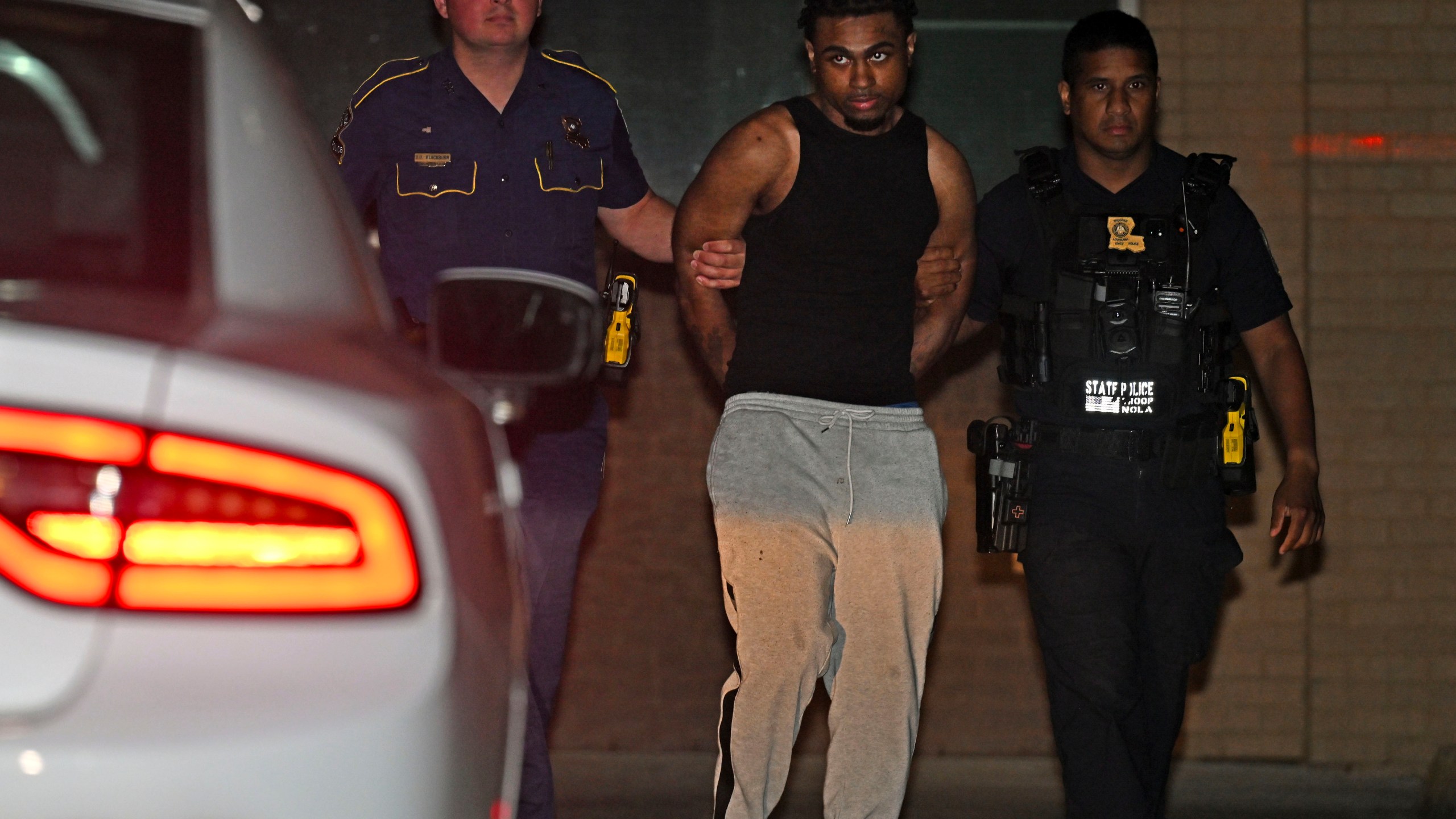 Troopers with Louisiana State Police escort Orleans Parish Prison escapee Lenton Vanburen to a waiting vehicle late Monday, May 26, 2025, at Louisiana State Police Headquarters after he was captured in Baton Rouge, La. (Hilary Scheinuk/The Advocate via AP)