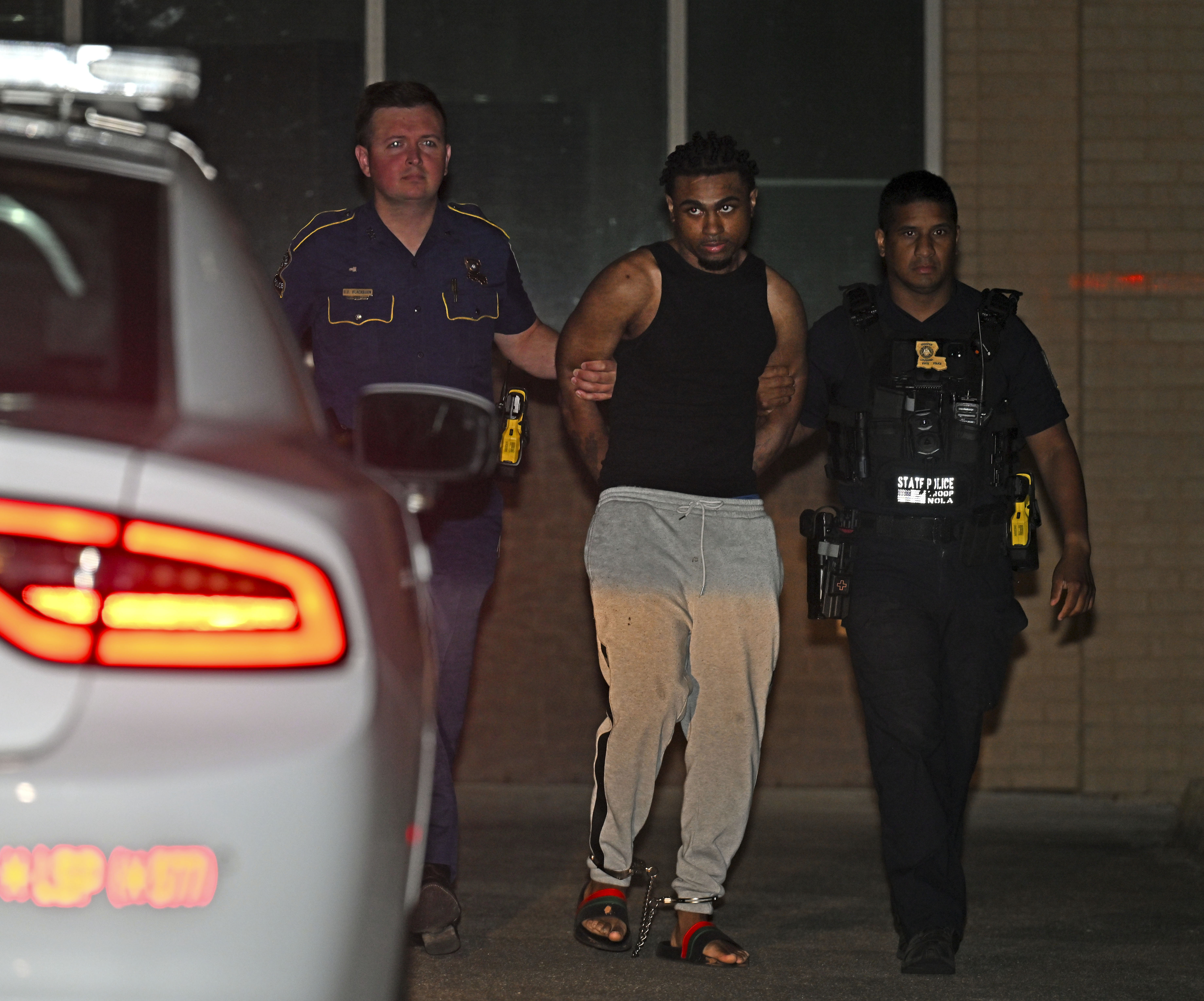 Troopers with Louisiana State Police escort Orleans Parish Prison escapee Lenton Vanburen to a waiting vehicle late Monday, May 26, 2025, at Louisiana State Police Headquarters after he was captured in Baton Rouge, La. (Hilary Scheinuk/The Advocate via AP)