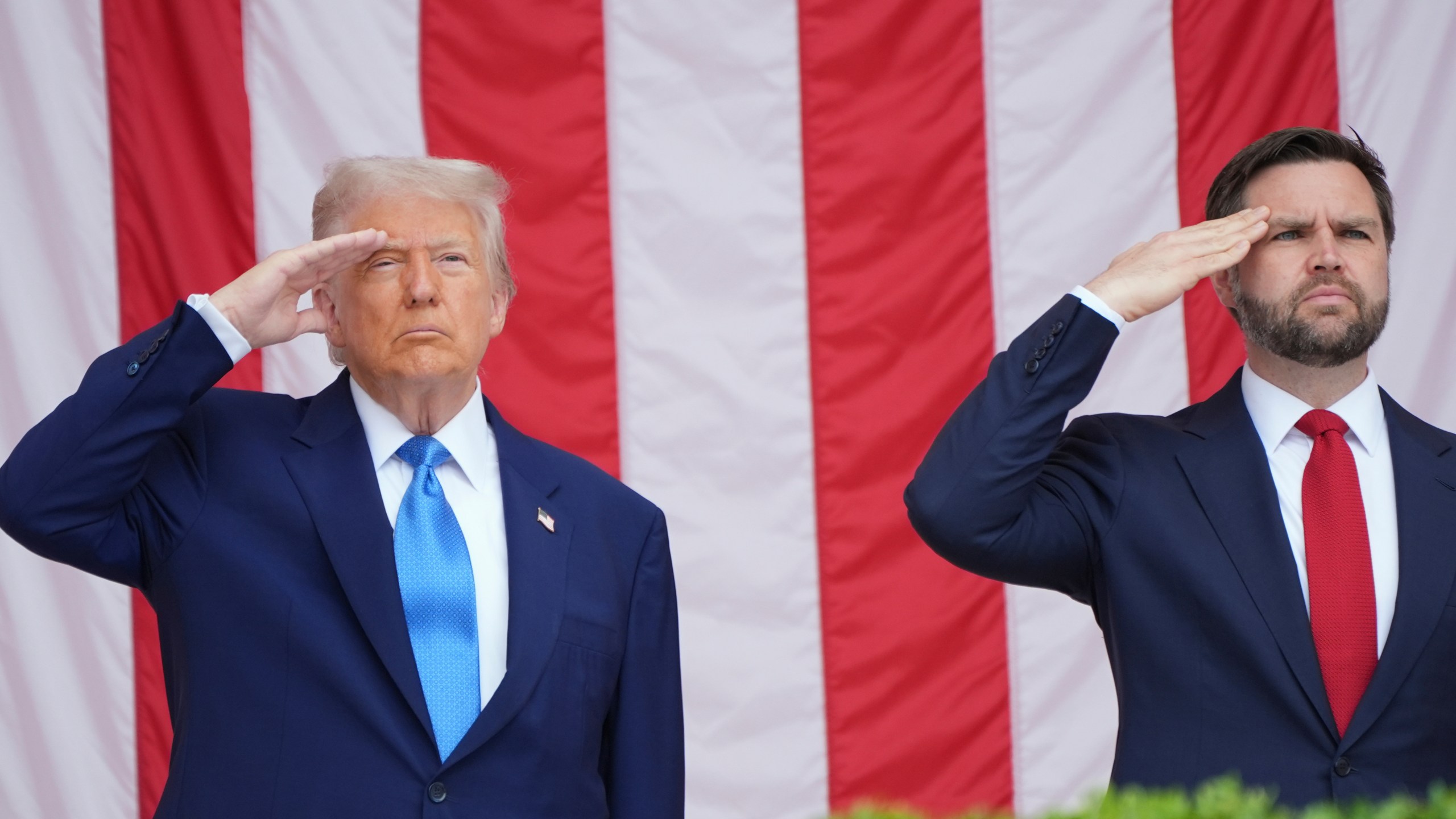 President Donald Trump and Vice President JD Vance salute as they attend the 157th National Memorial Day Observance at Arlington National Cemetery, Monday, May 26, 2025, in Arlington, Va. (AP Photo/Jacquelyn Martin)