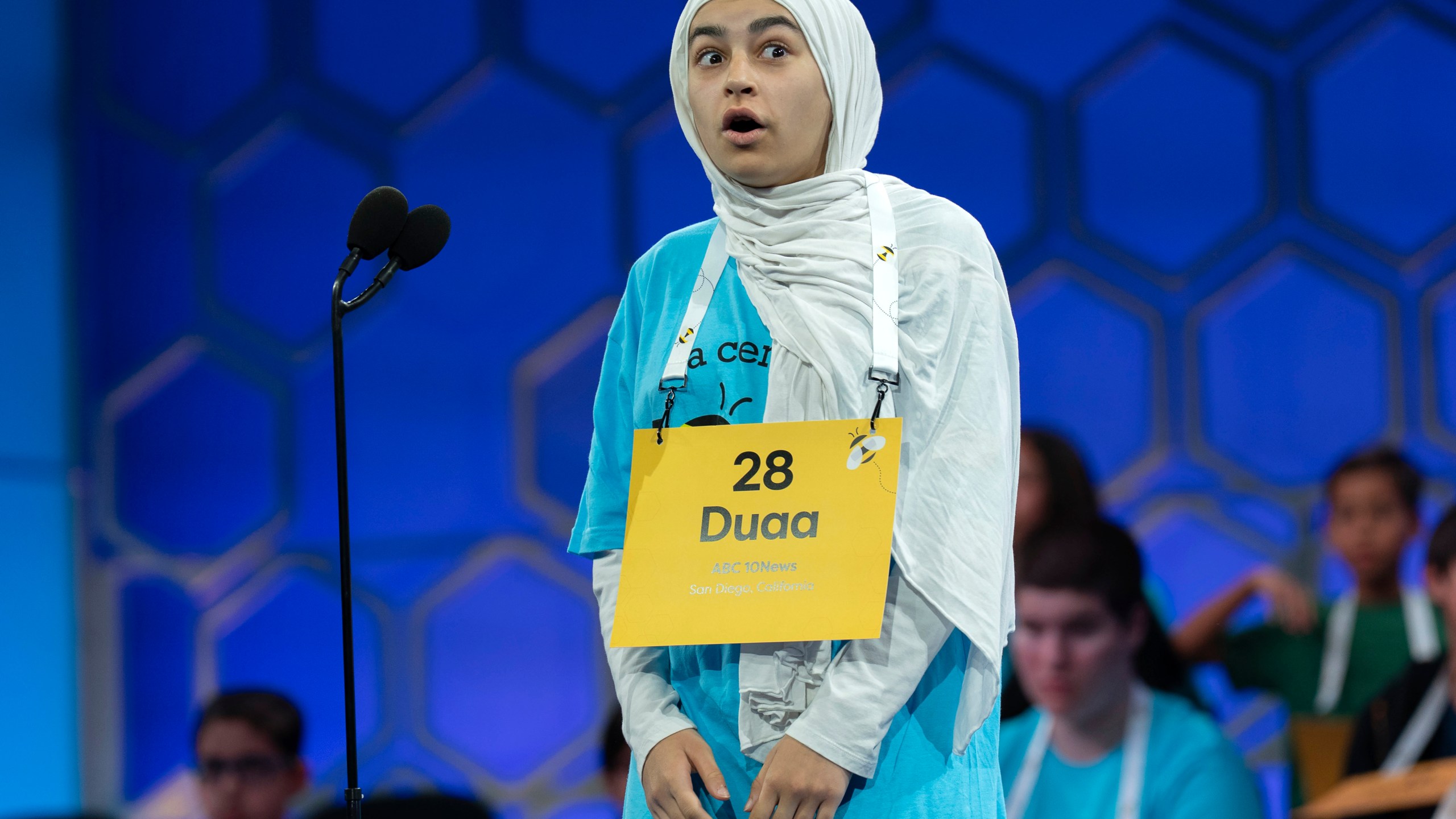Duaa Siyah Ouznali, 13, of San Diego, reacts after correctly spelling her word as she competes during the first preliminary round of the Scripps National Spelling Bee at the Gaylord National Resort & Convention Center, Tuesday, May 27, 2025, in Oxon Hill, Md. (AP Photo/Jose Luis Magana)