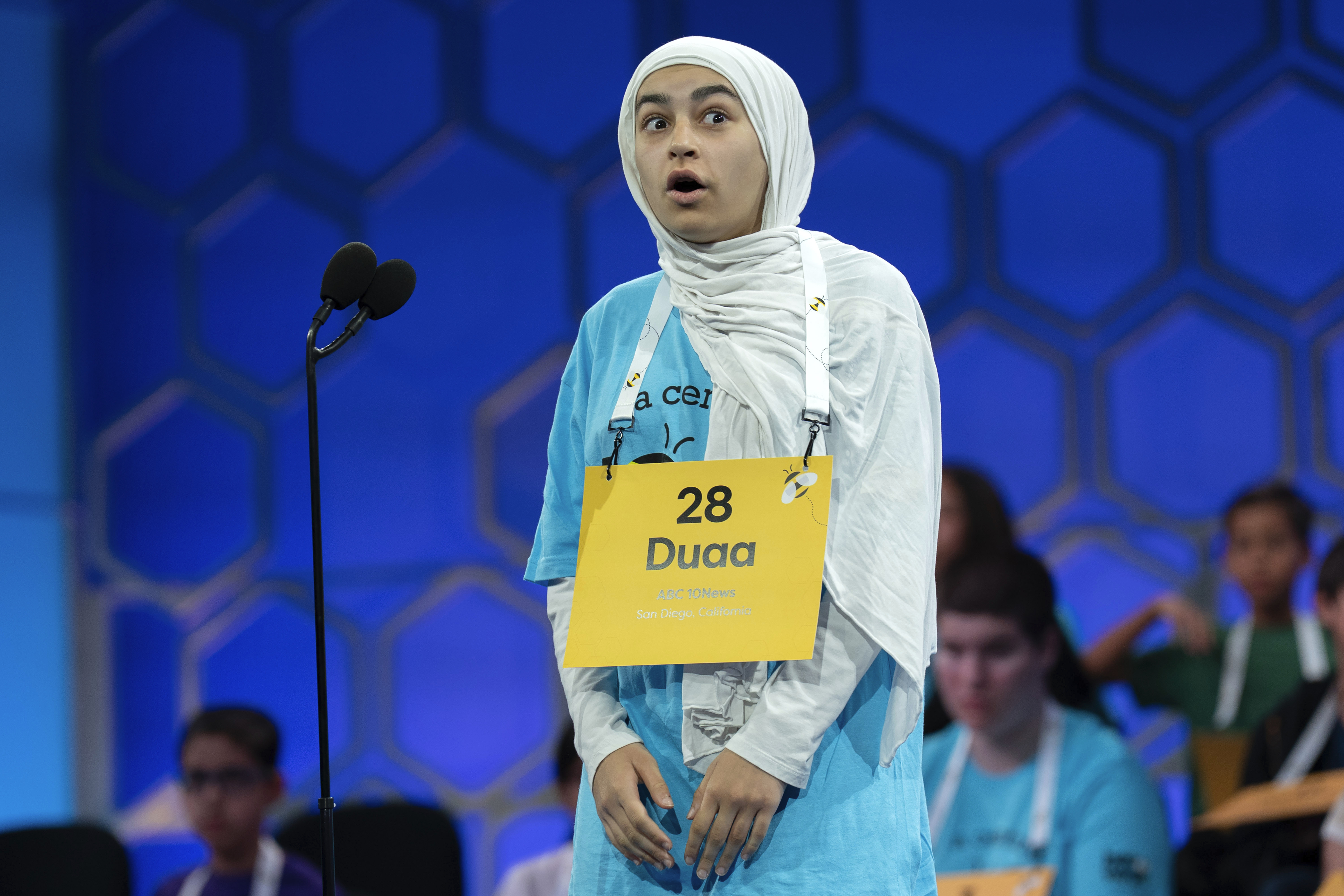 Duaa Siyah Ouznali, 13, of San Diego, reacts after correctly spelling her word as she competes during the first preliminary round of the Scripps National Spelling Bee at the Gaylord National Resort & Convention Center, Tuesday, May 27, 2025, in Oxon Hill, Md. (AP Photo/Jose Luis Magana)